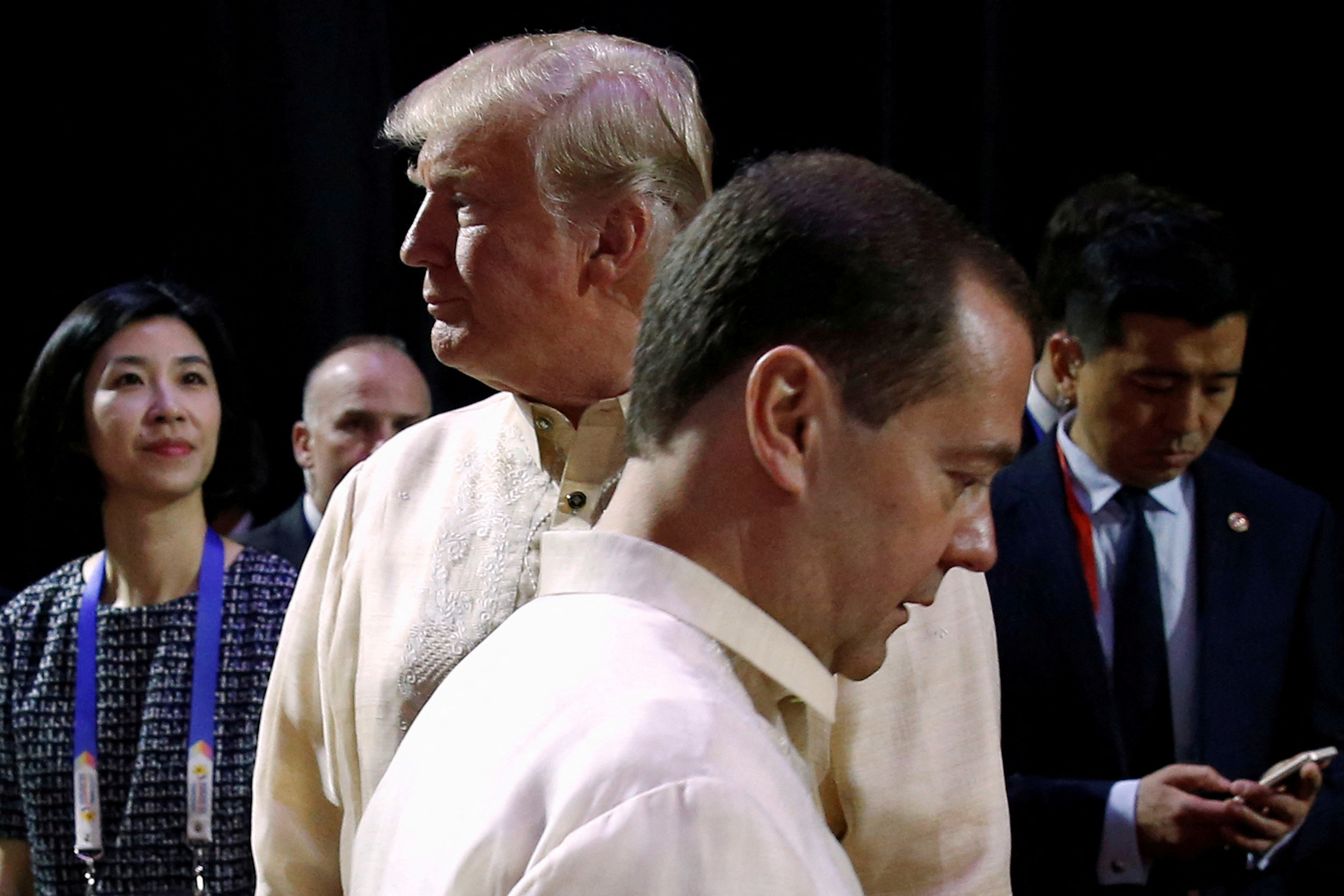 FILE PHOTO: Russia's Prime Minister Dmitry Medvedev (L) crosses paths with U.S. President Donald Trump at the Association of Southeast Asian Nations (ASEAN) Summit gala dinner in Manila, Philippines November 12, 2017. REUTERS/Jonathan Ernst/File Photo