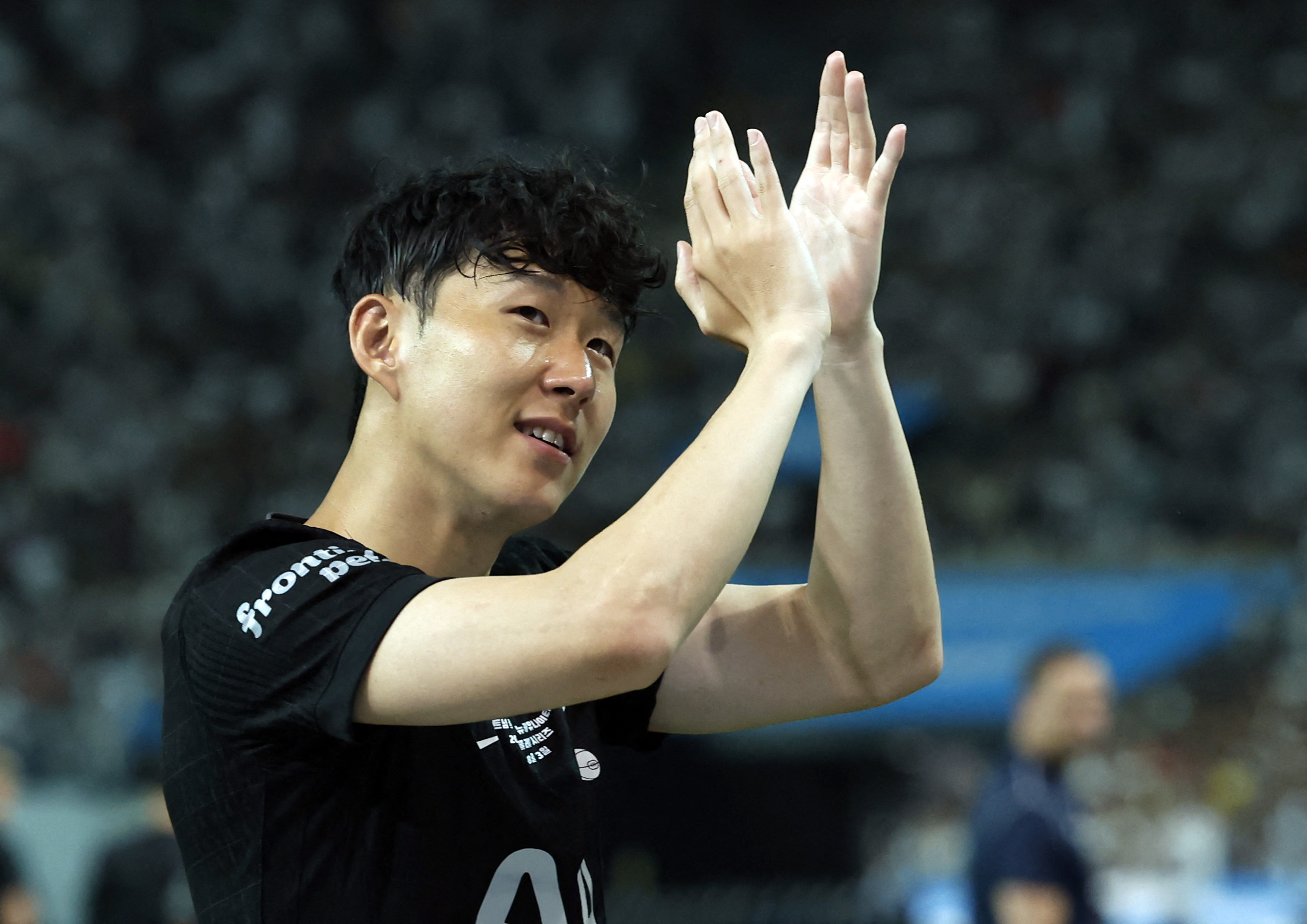 Son Heung-Min applauds fans.