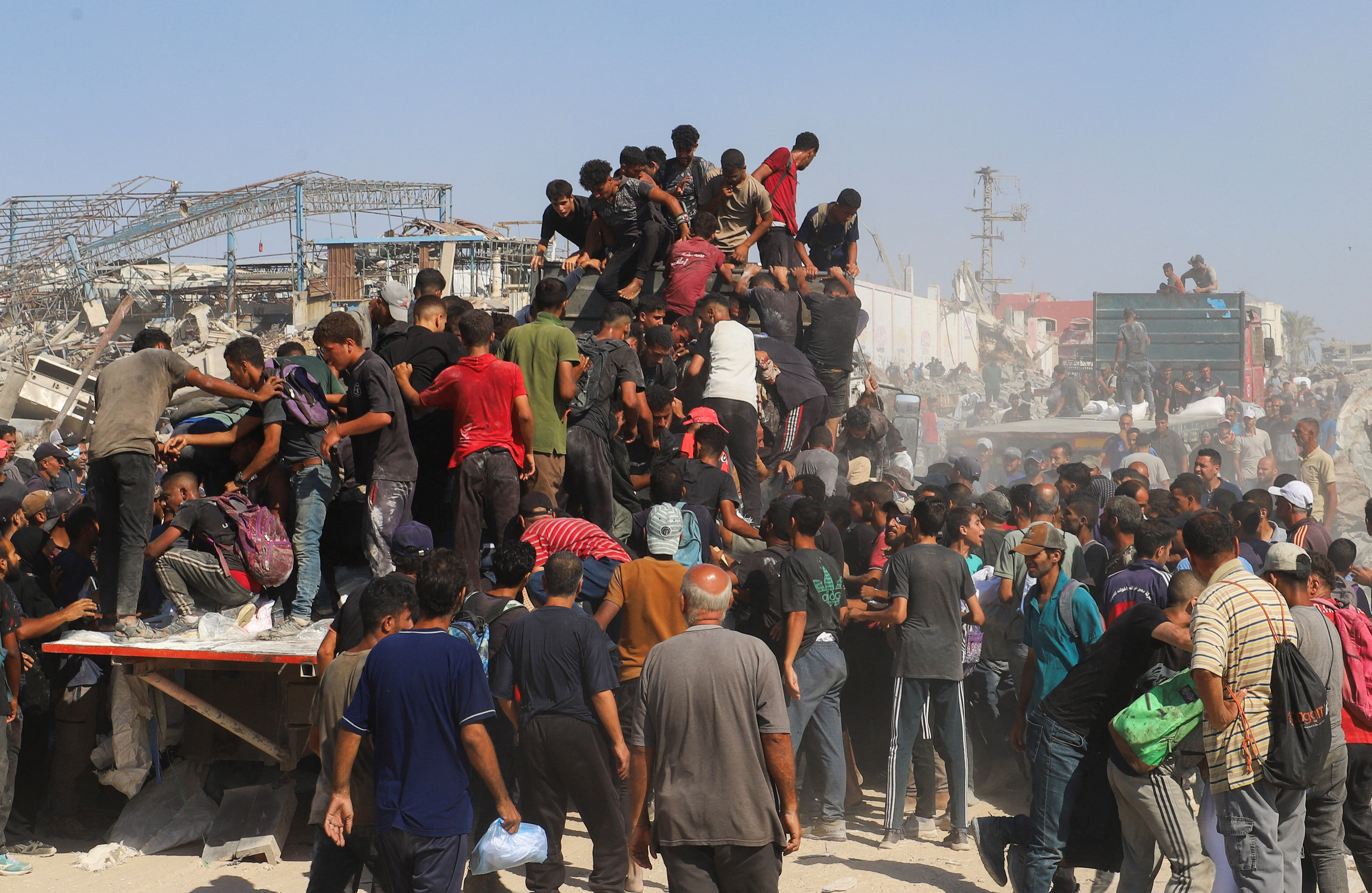 people crowd on to a truck
