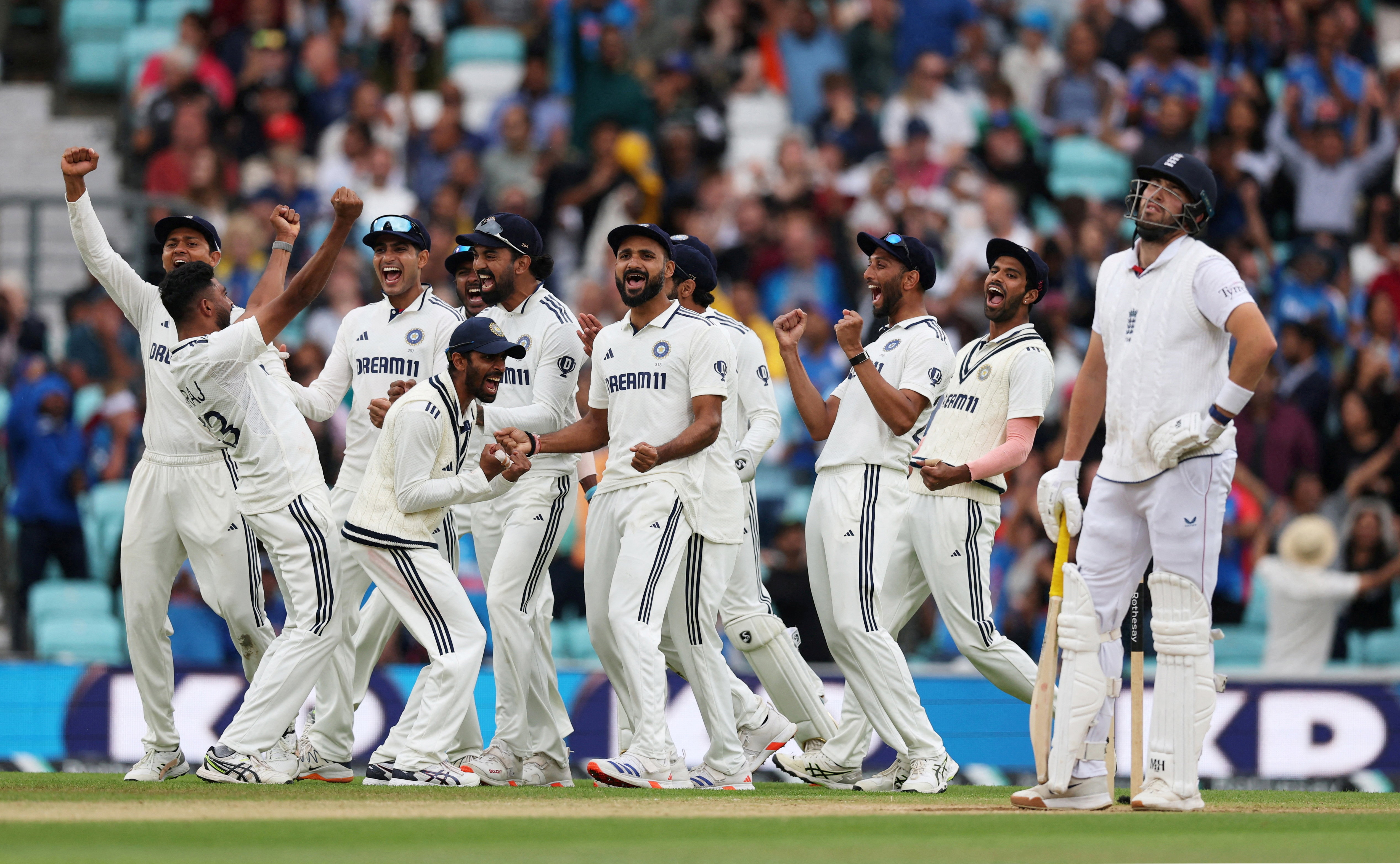 India's Mohammed Siraj celebrates taking the wicket of England's Jamie Overton with teammates