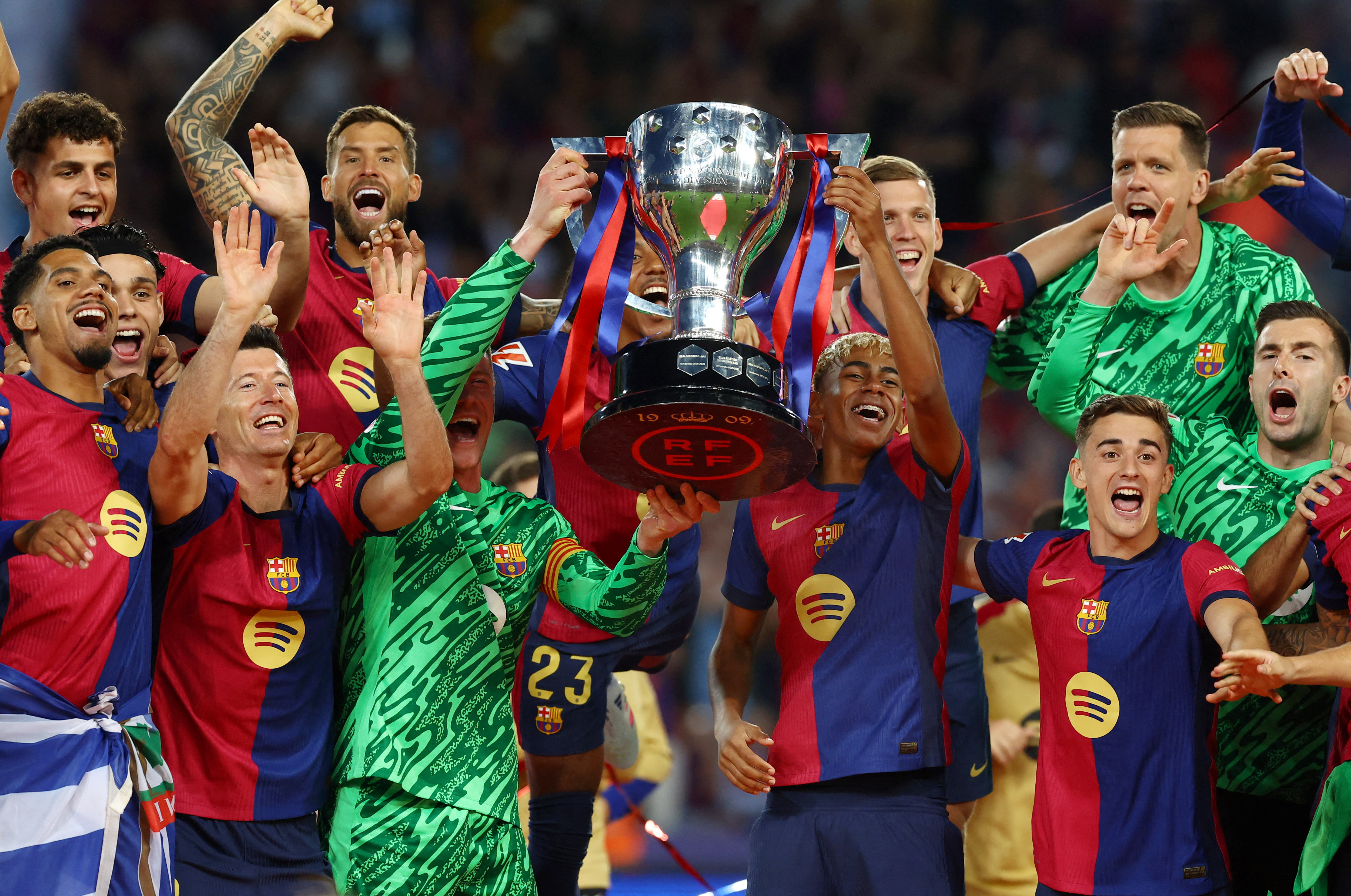 Barcelona's Lamine Yamal and Marc-Andre ter Stegen lift the trophy after winning LaLiga
