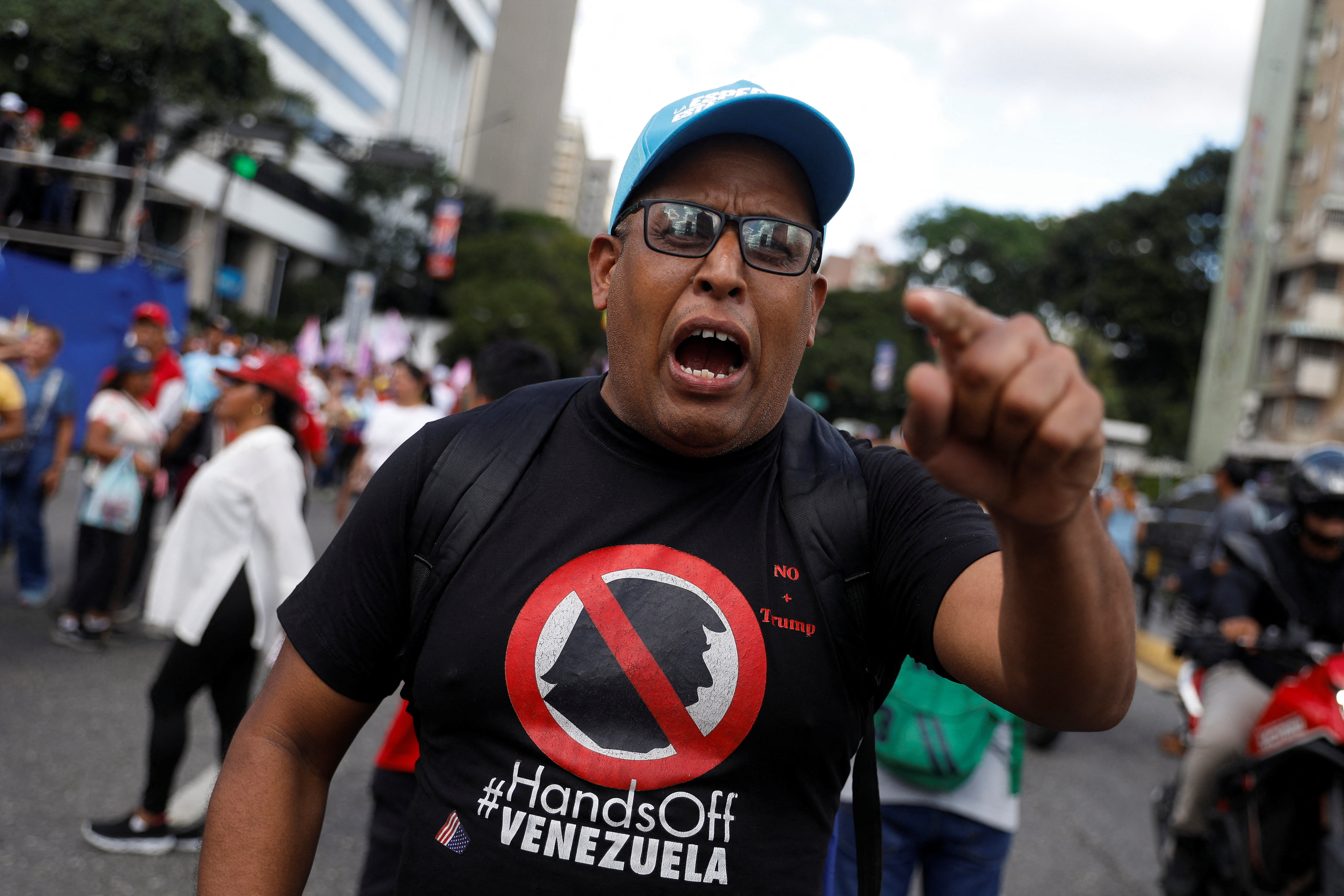 A Venezuelan government supporter participates in a march in support of Venezuelan President Nicolas Maduro, after U.S. Attorney General Pam Bondi announced that the United States doubled its reward for information leading to his arrest over allegations of drug trafficking and links to criminal groups, in Caracas, Venezuela, August 11, 2025. REUTERS/Leonardo Fernandez Viloria