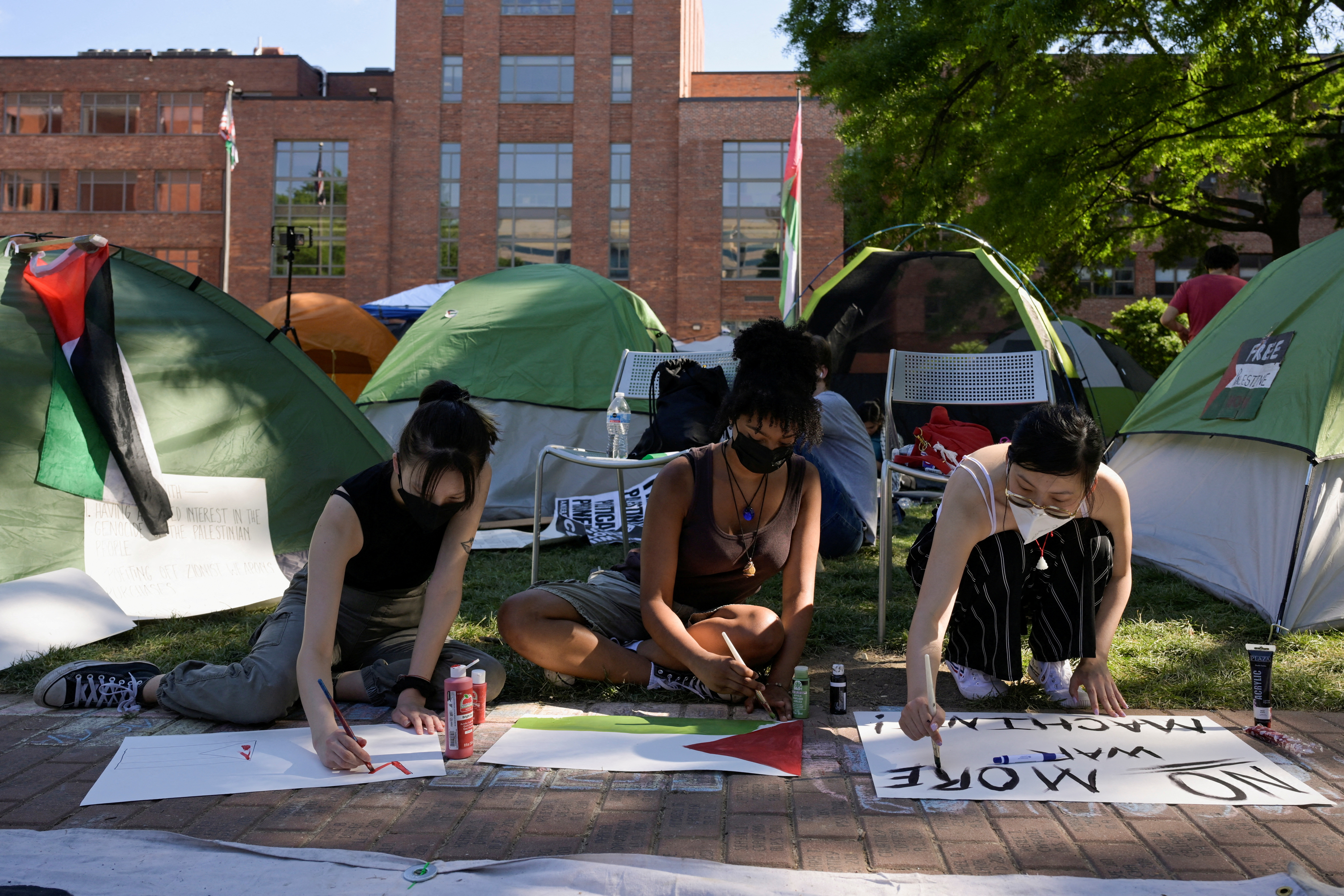 ctivists make protest signs inside a pro-Palestinian encampment at George Washington University in Washington, DC., May 2, 2024. [File: Craig Hudson/Reuters]
