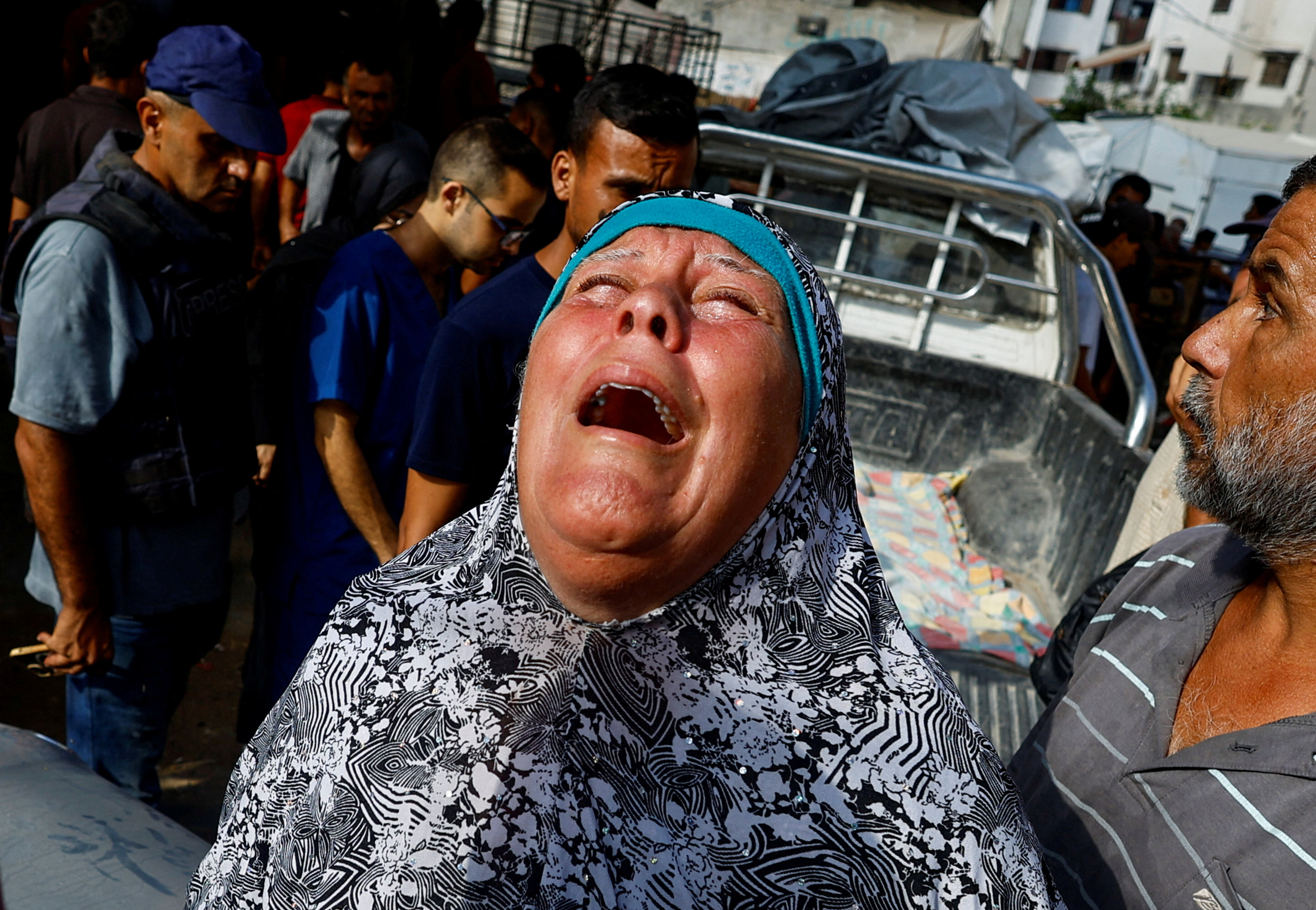 A mourner reacts during the funeral of Palestinians killed in Israeli fire while seeking aid