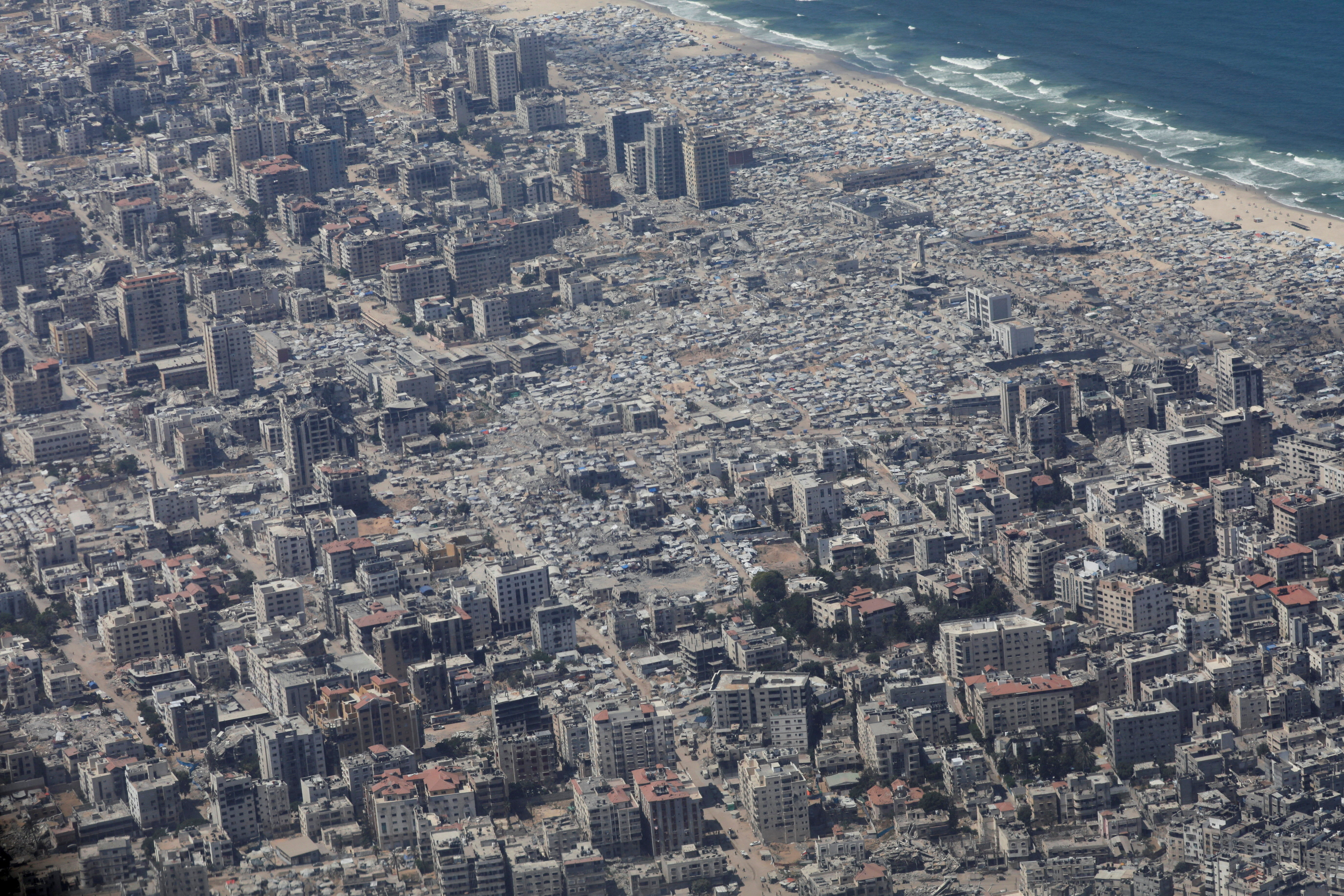 An aerial view from a Jordanian military aircraft shows the Gaza Strip, before humanitarian aid is airdropped over it, in Gaza, August 17, 2025. [Alaa Al Sukhni/Reuters]