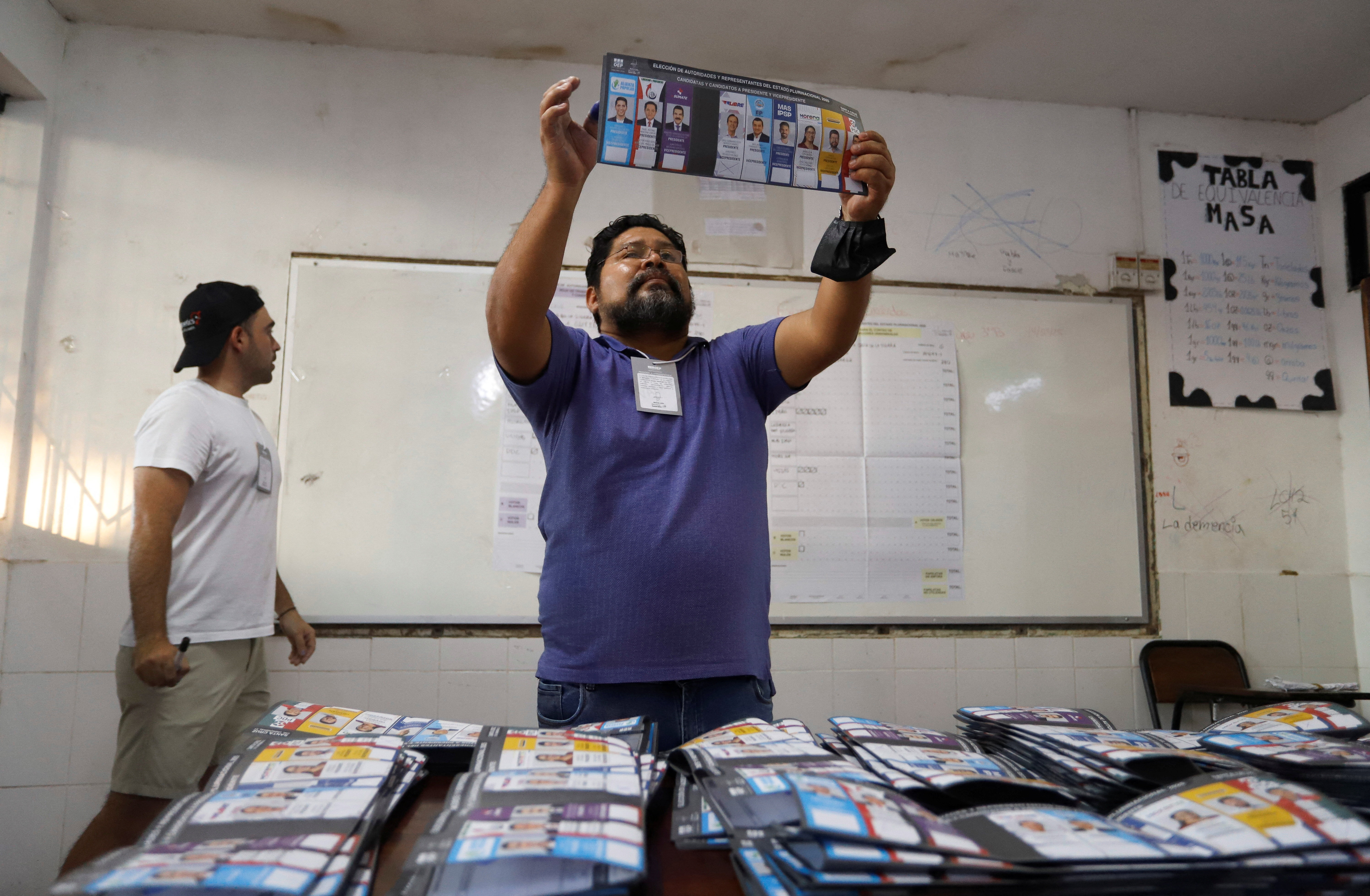 a man looks at a piece of paper with faces on it