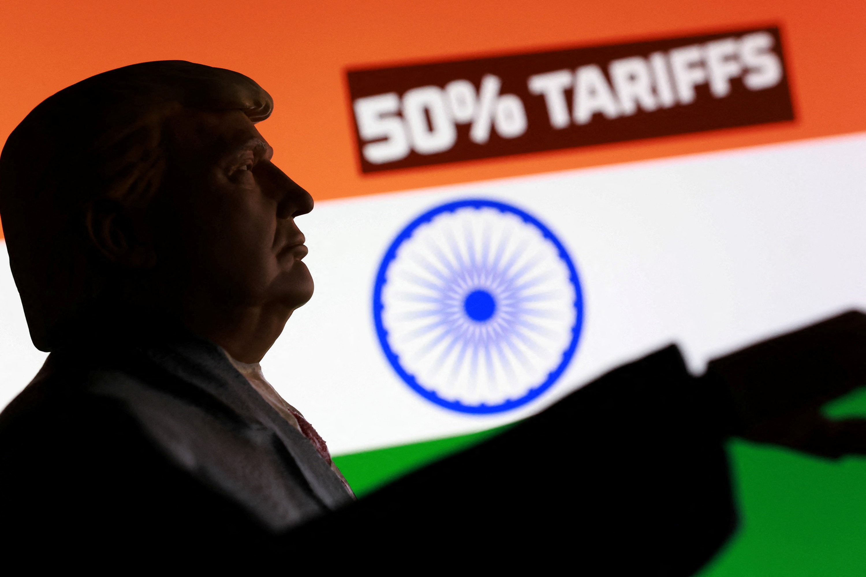 An Indian flag, 3D-printed miniature model depicting US President Donald Trump and the phrase "50% tariffs" are seen in this illustration taken on August 27, 2025.