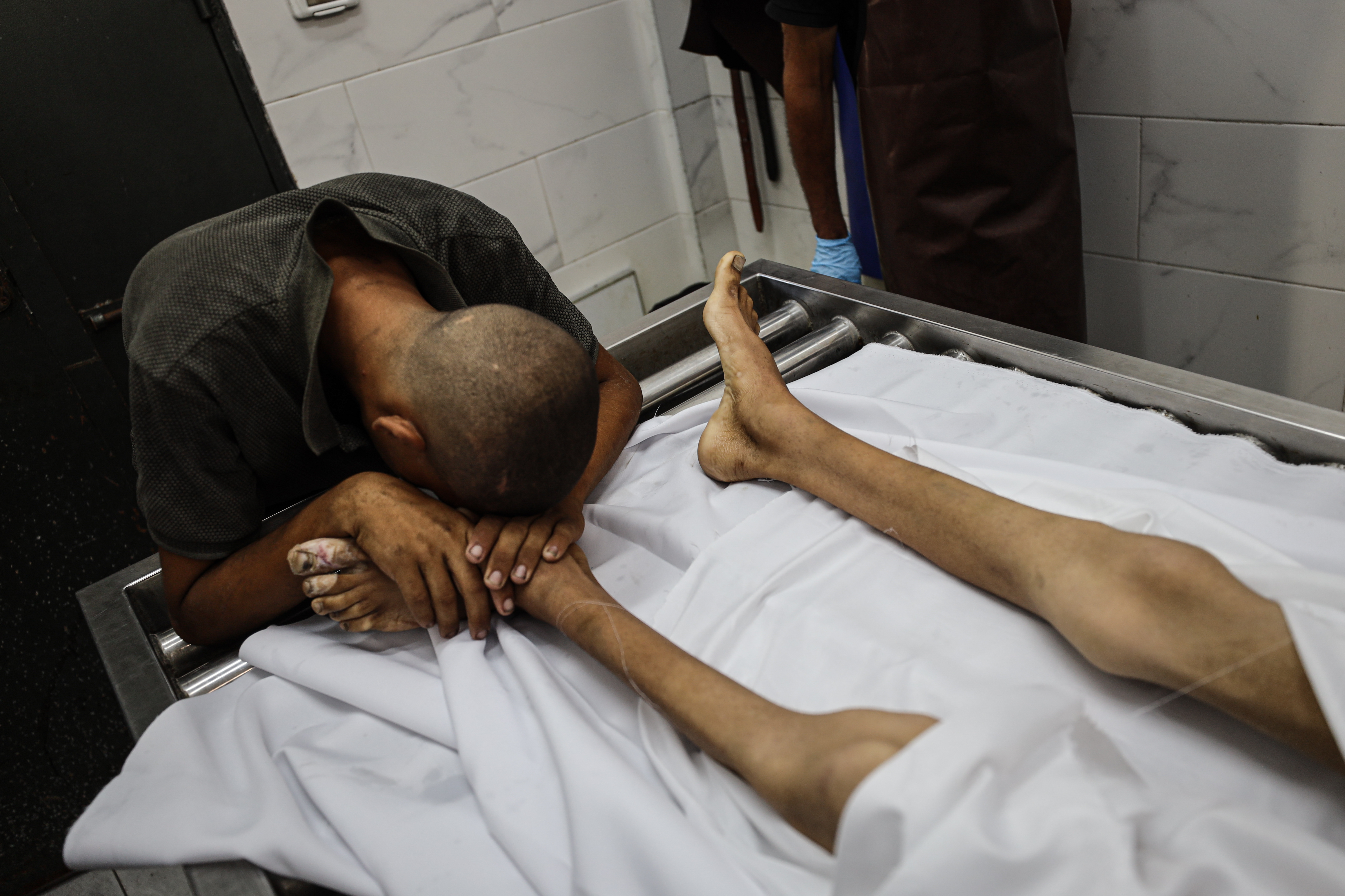 The body of Atef Abu Khater, 17, who died from malnutrition, is seen being taken from Al Helou Hospital in Gaza City, Gaza on August 2, 2025.