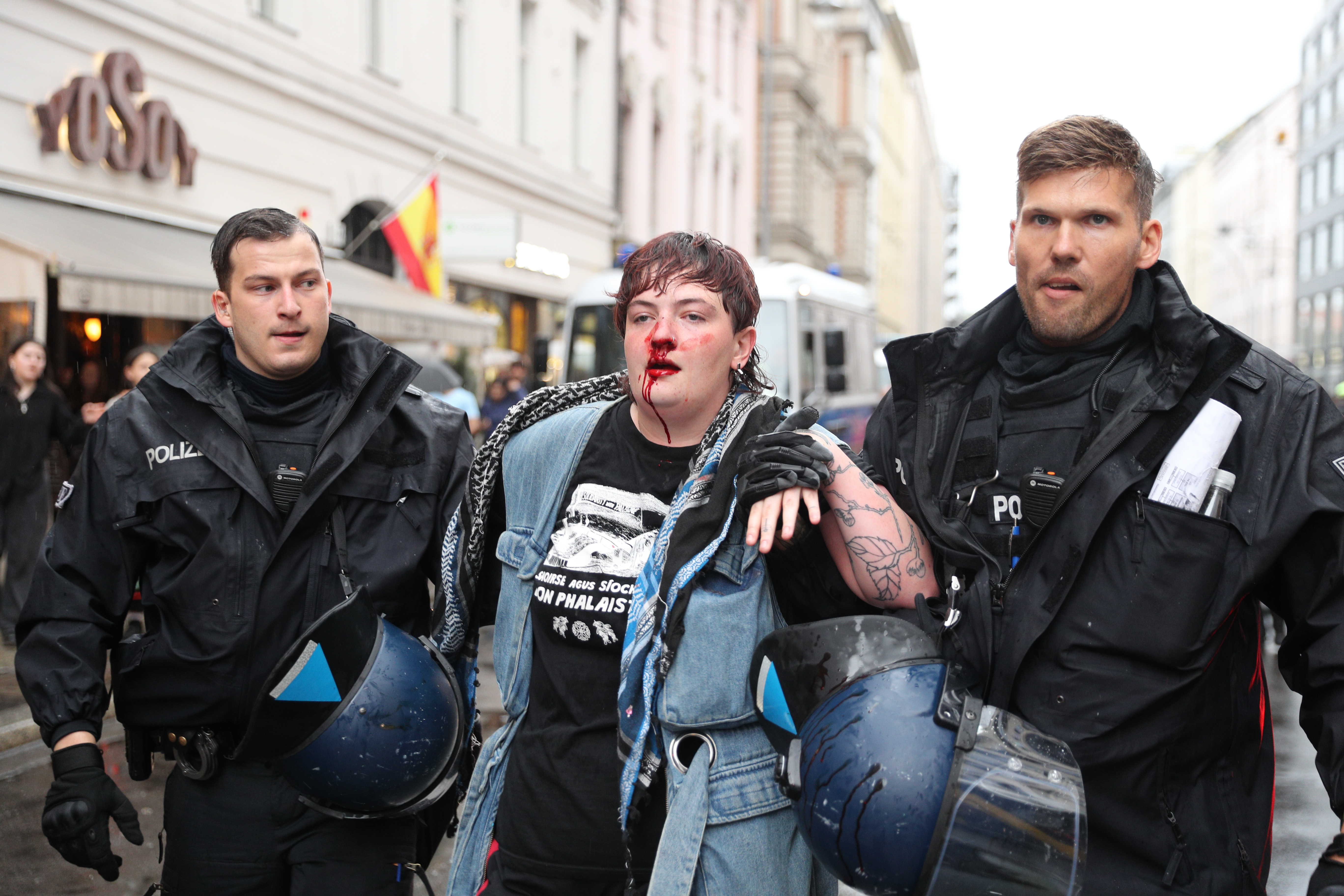 Injured protestor Kitty O’Brien is detained by police during a demonstration against the killing of journalists and Israeli attacks in Gaza at Hackescher Markt in Berlin, Germany on August 28, 2028.