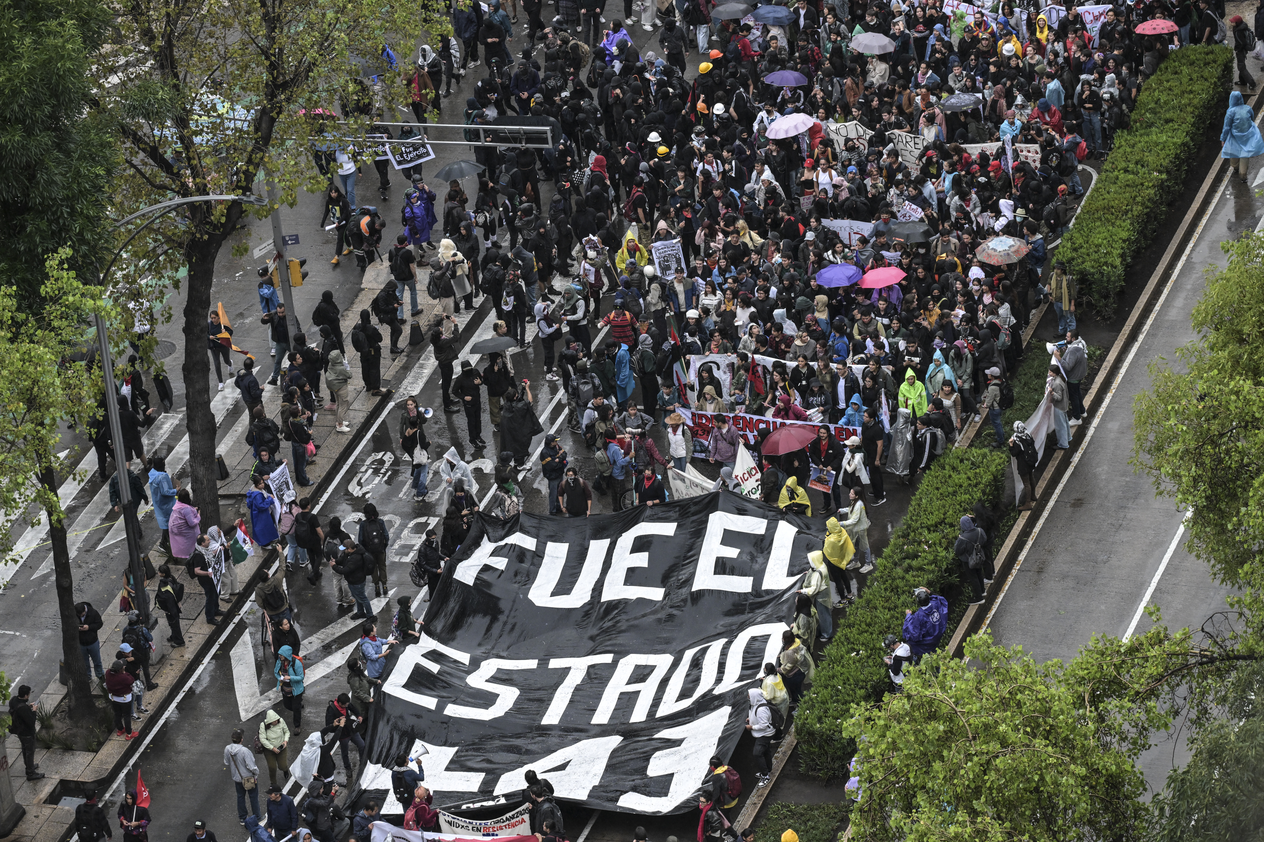 Demonstrators march through a Mexico City street to commemorate the disappearance of the Ayotzinapa 43.