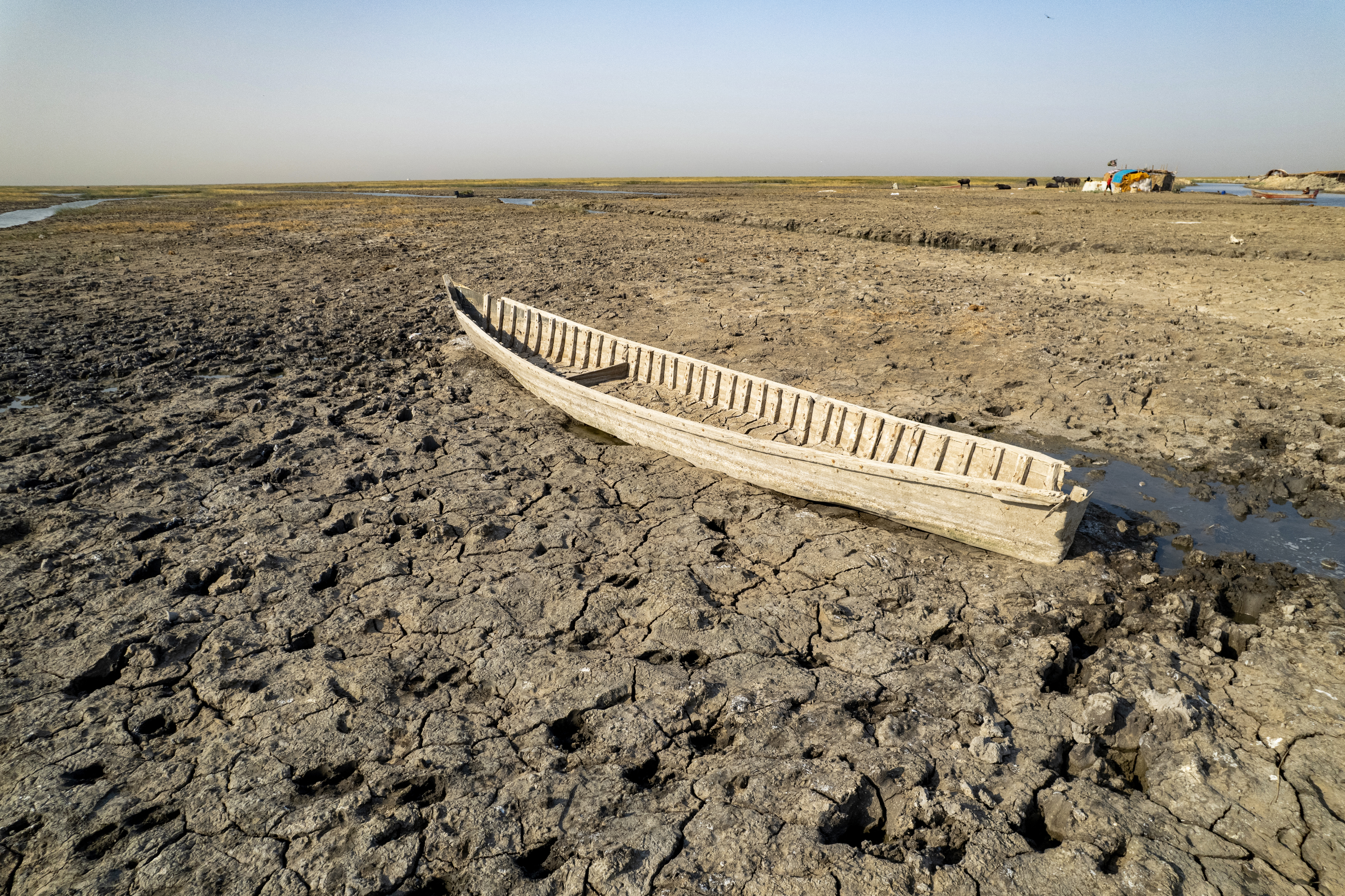 A traditional boat is stranded in the mud as water recedes in the drought-striken Chibayish marshes in Iraq's southern Dhi Qar province on July 30, 2025.