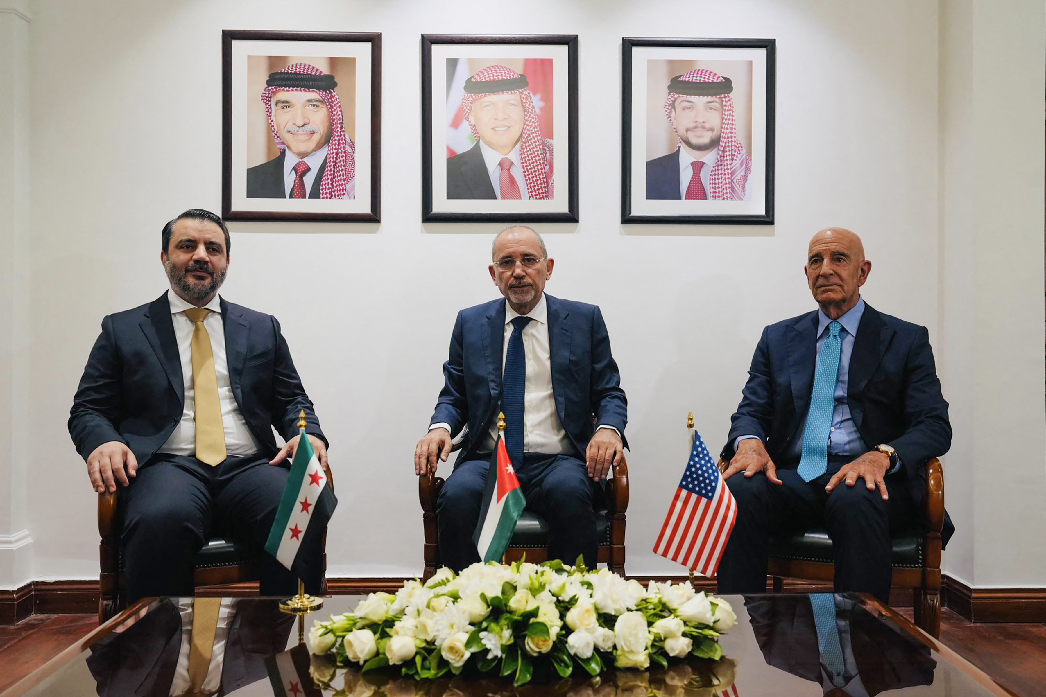 This handout picture released by the Jordanian Foreign Ministry shows (L to R) Syria's interim foreign minister Asaad al-Shaibani, Jordan's Foreign Minister Ayman Safadi, and US special envoy for Syria Tom Barrack meeting in Amman on August 12, 2025.