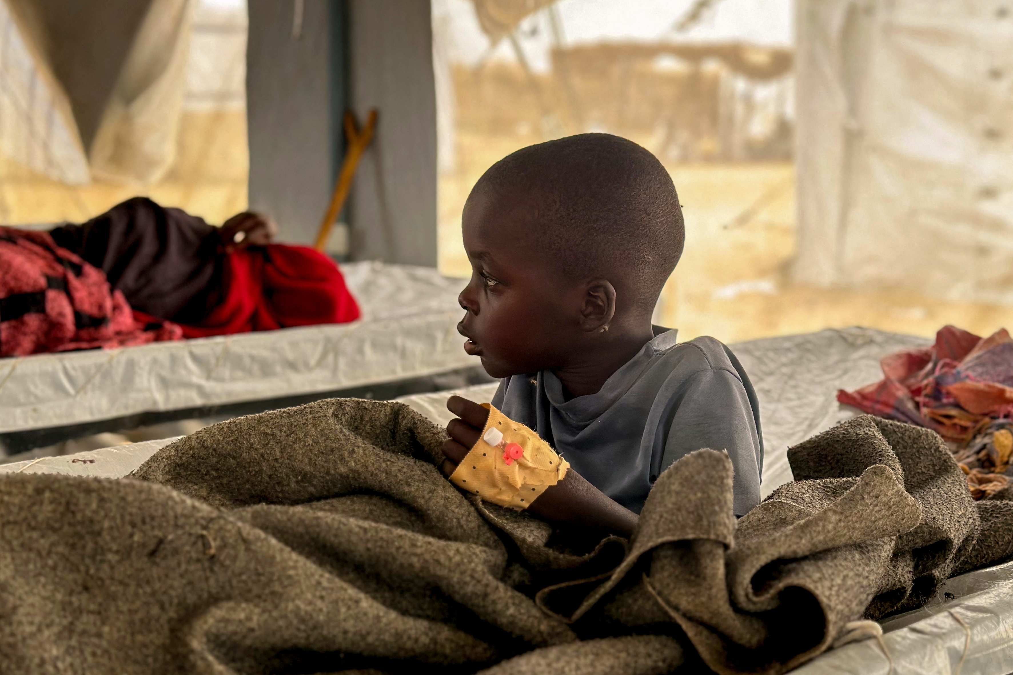 A child infected with cholera receives treatment.
