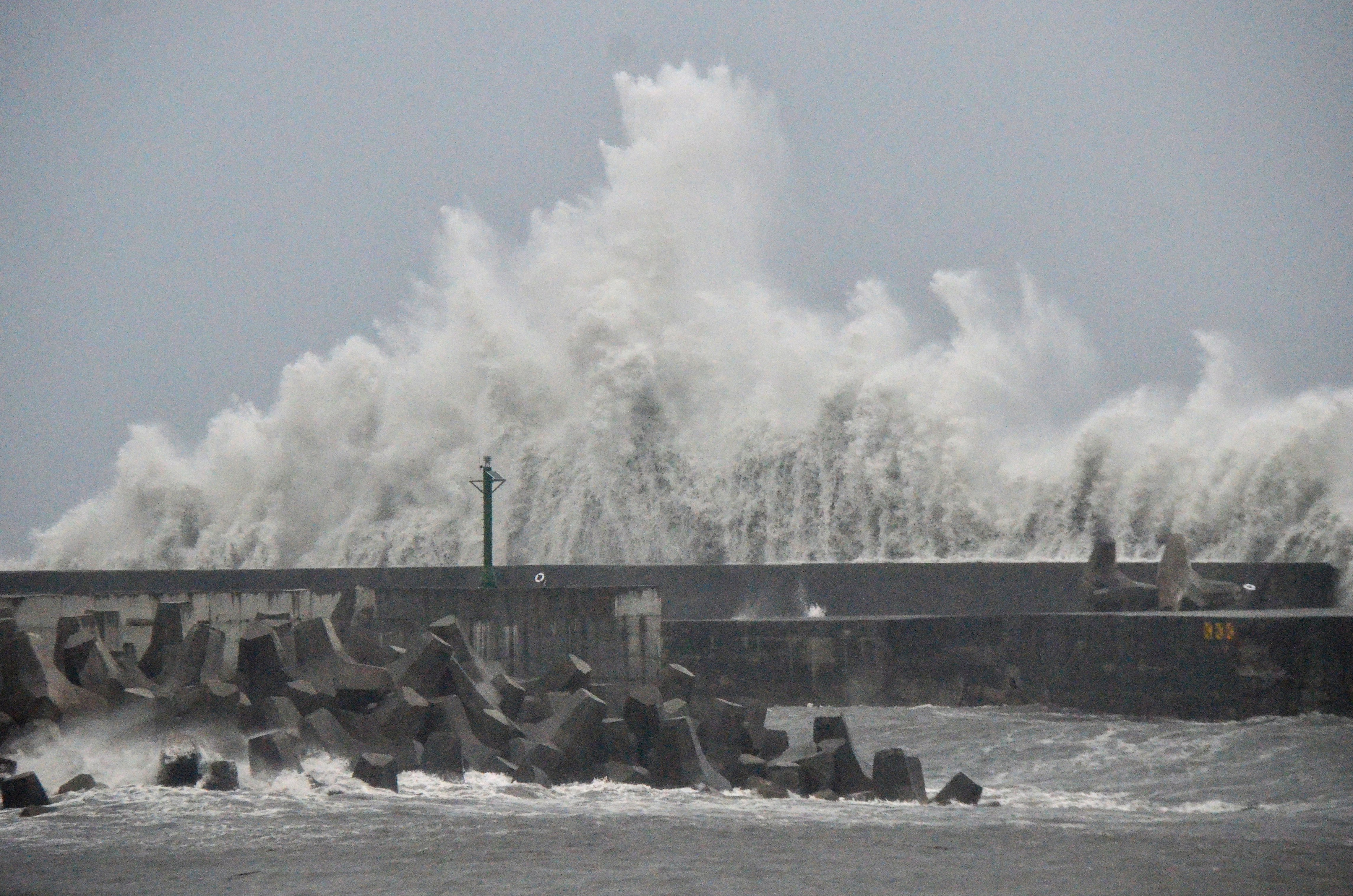 This picture taken and released by Taiwans Central News Agency (CNA) on August 13, 2025 shows waves generated by Typhoon Podul breaking along the coast in Taitung. Thousands of people sheltered and fishermen secured their boats across storm-battered southern Taiwan on August 13 as Typhoon Podul intensified on its approach to the island. (Photo by CNA / AFP)