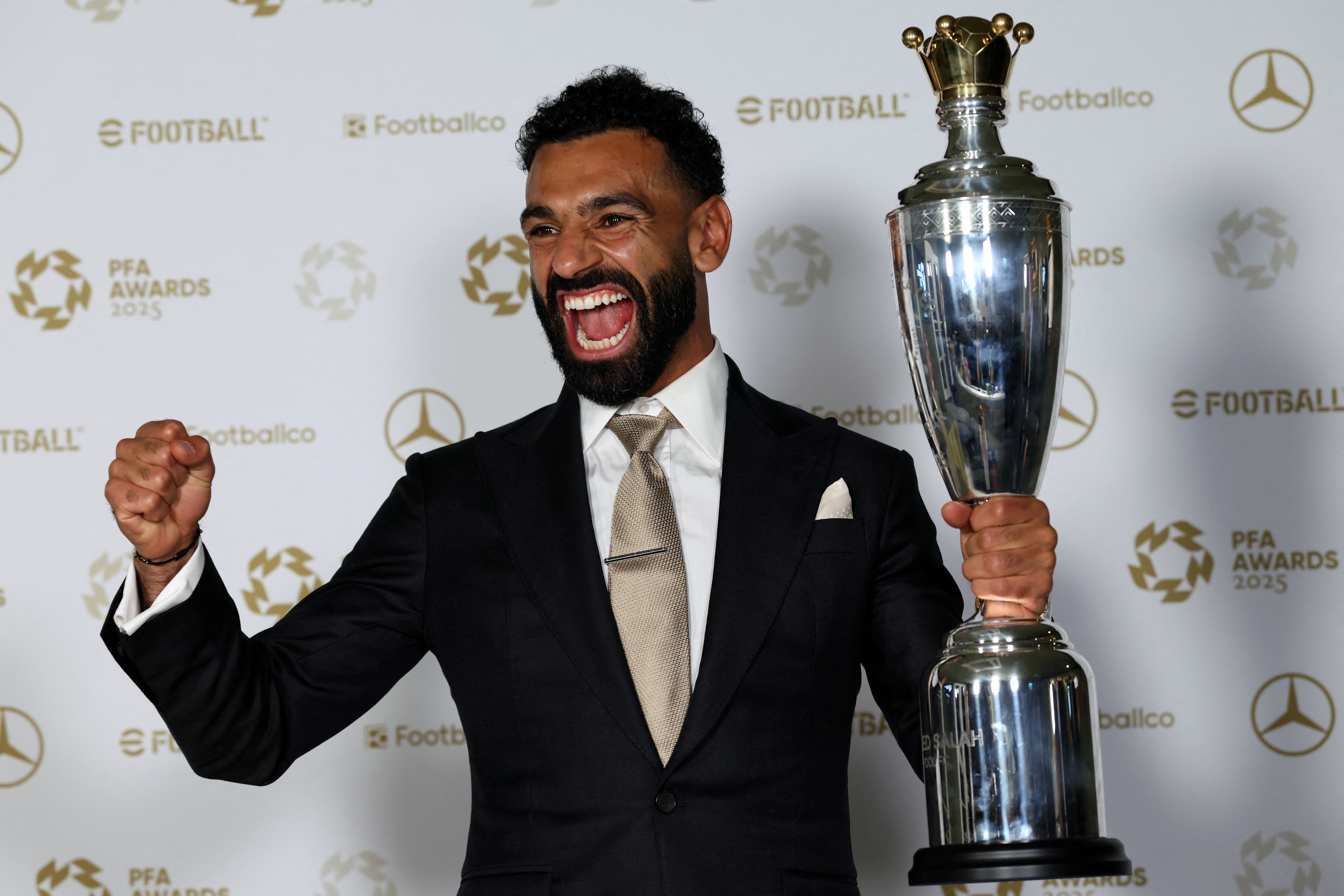 Mohamed Salah poses with an award.