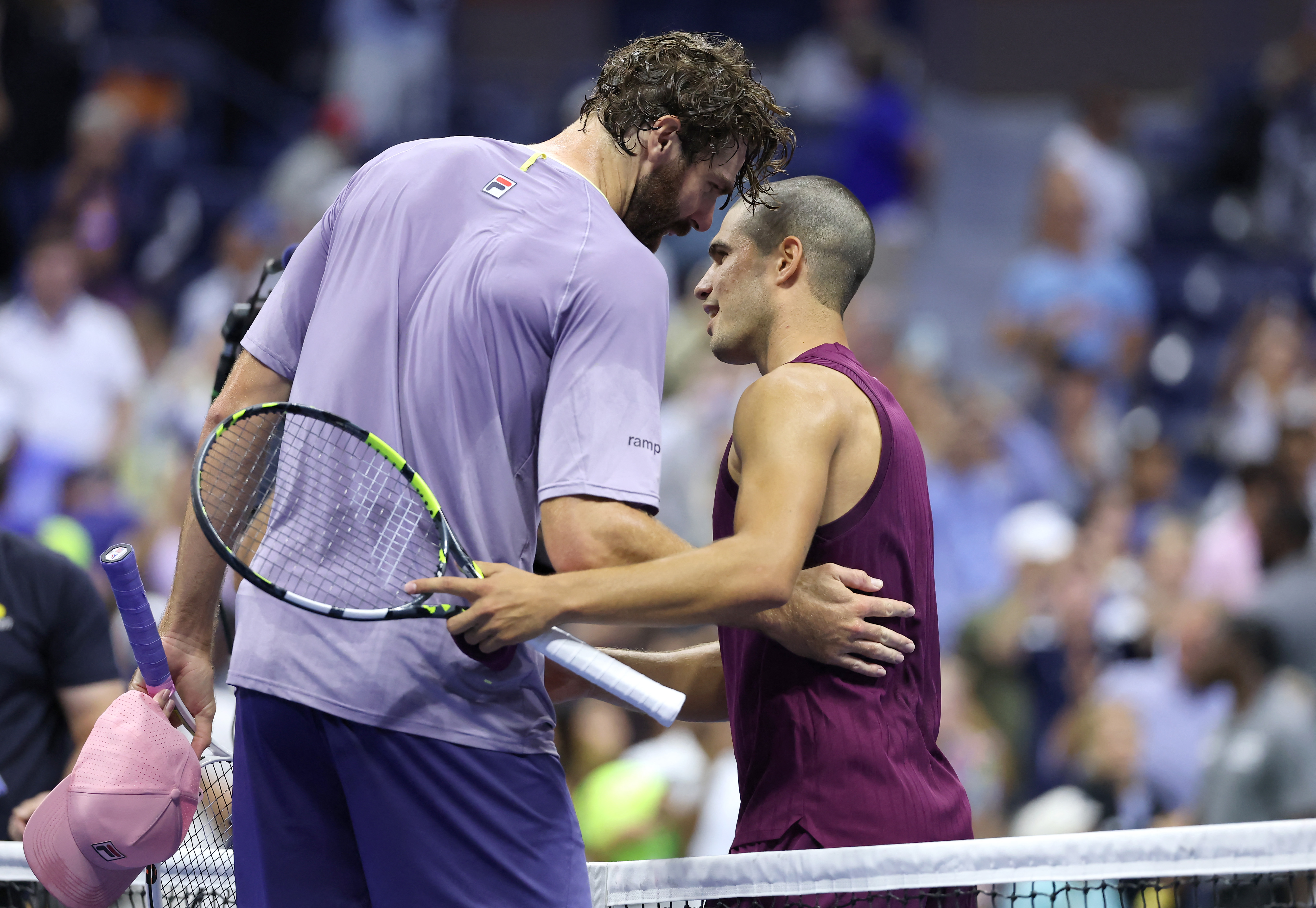 Reilly Opelka and Carlos Alcaraz shake hands after match.