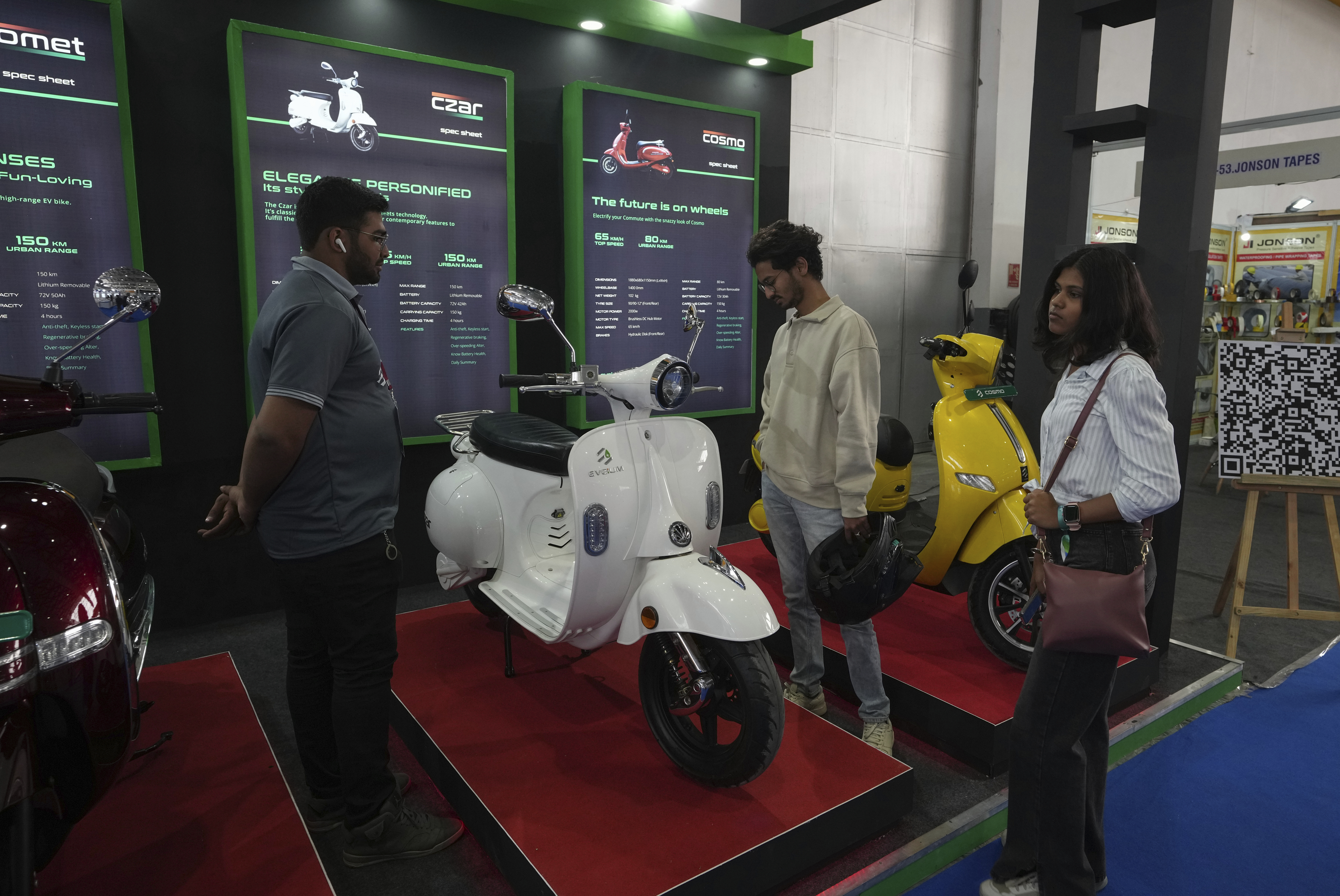 Visitors check an e scooter at the Electric Vehicle Technology Expo in Hyderabad, India