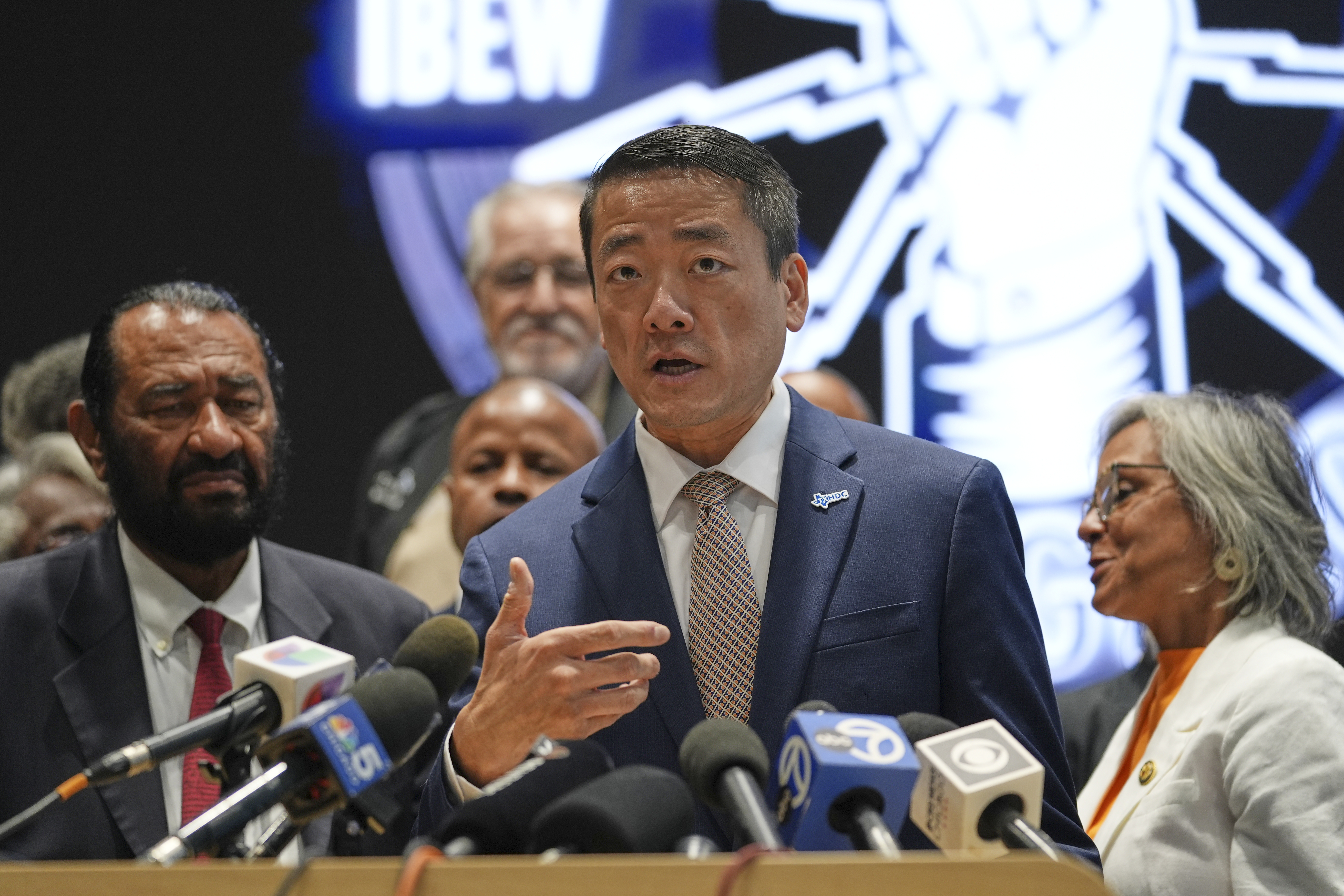 Democratic Texas Rep. Gene Wu, center, surrounded by other Texas House Democrats and Democratic members of Congress, speaks during a press conference in Warrenville, Illinois on August 4, 2025.