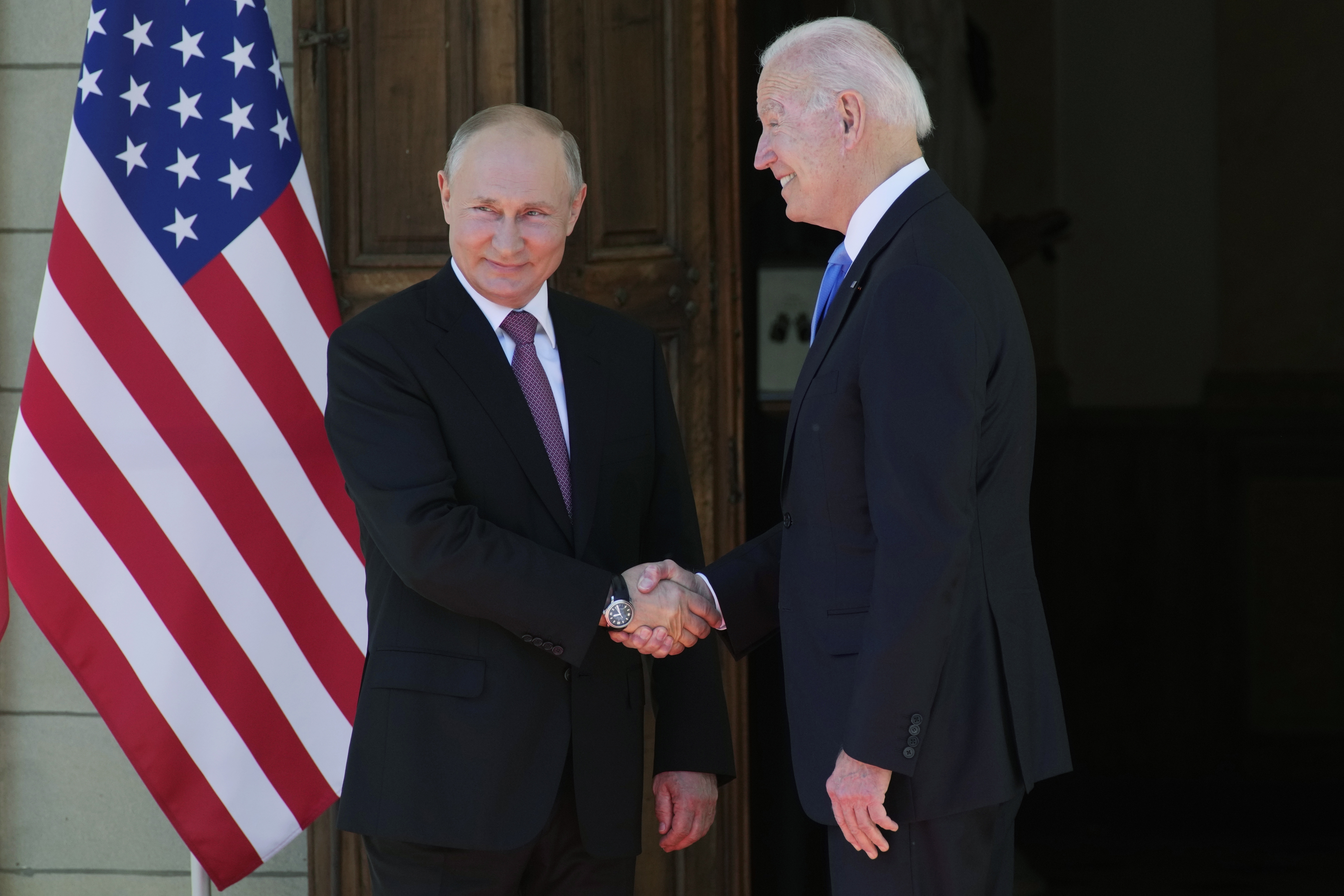 FILE - Russian President Vladimir Putin, left, and U.S President Joe Biden shake hands in Geneva, Switzerland, on June 16, 2021. (AP Photo/Alexander Zemlianichenko, Pool, File)