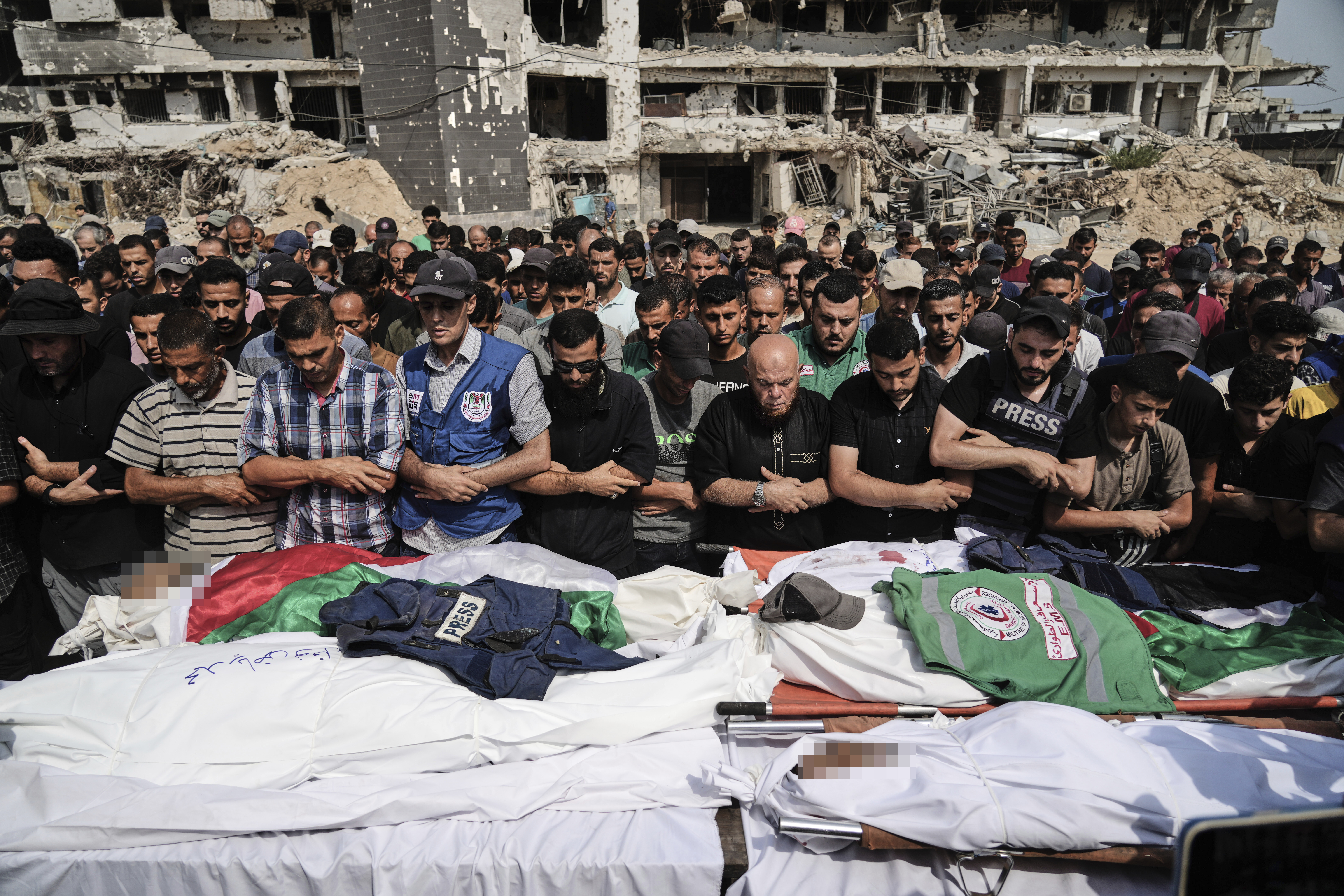 Palestinians pray over the bodies of journalists, including Al Jazeera correspondents Anas al-Sharif and Mohamed Qreiqeh, who were killed in an Israeli airstrike, during their funeral outside Gaza City's Shifa hospital complex, Monday, Aug. 11, 2025. [Jehad Alshrafi/AP]