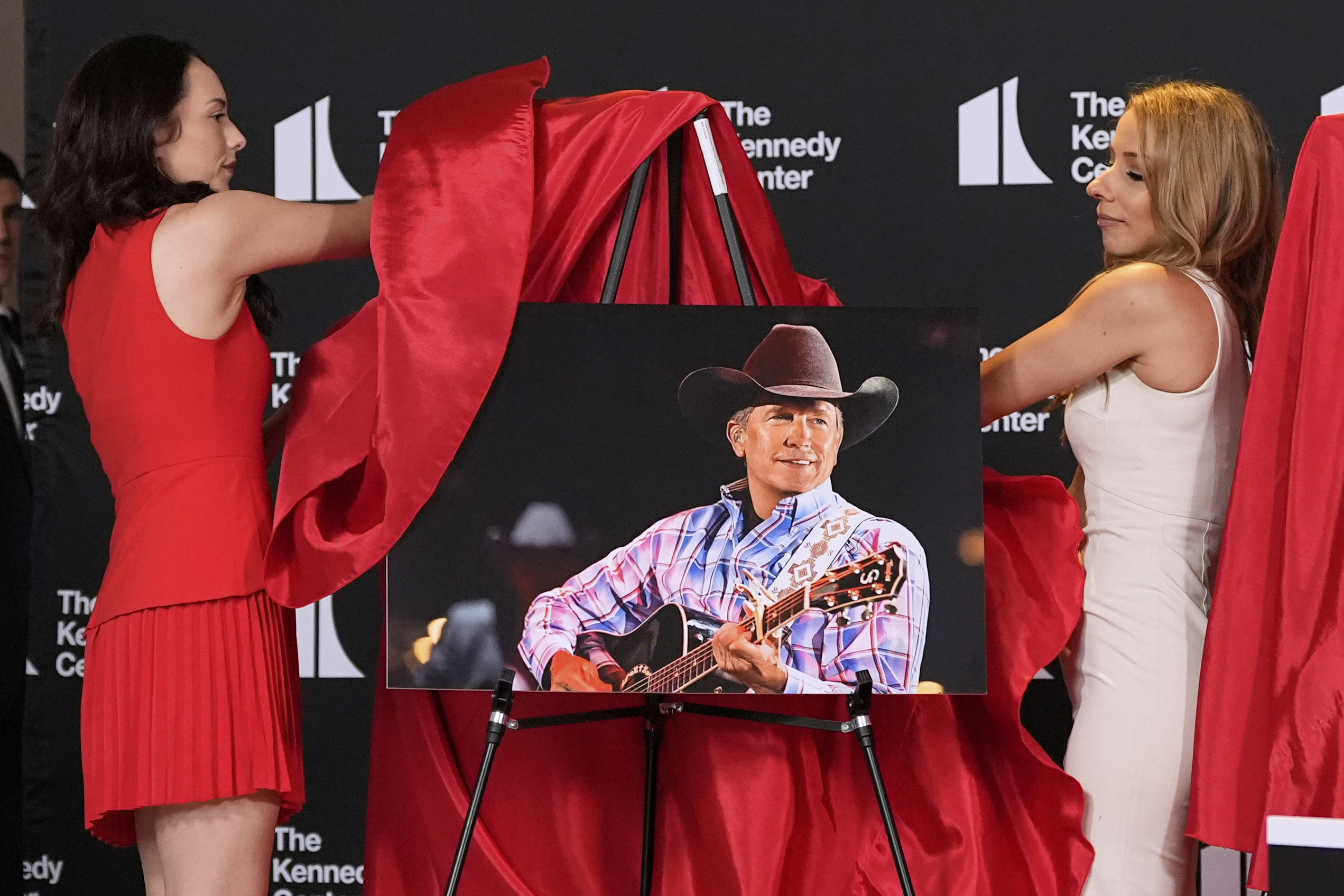 Presenters unveil a portrait of George Strait at the Kennedy Center.