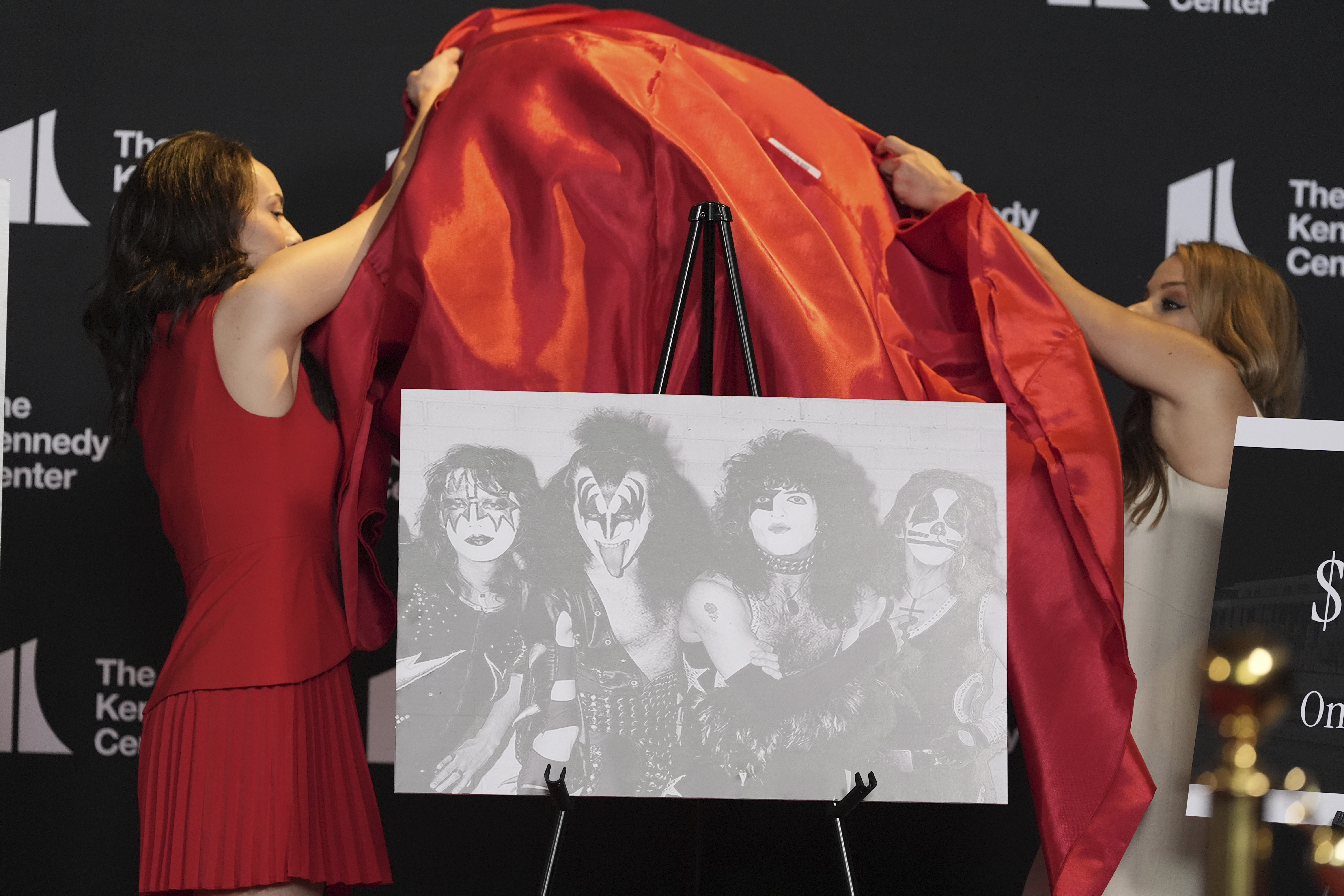 Presenters unveil a portrait of the rock group KISS