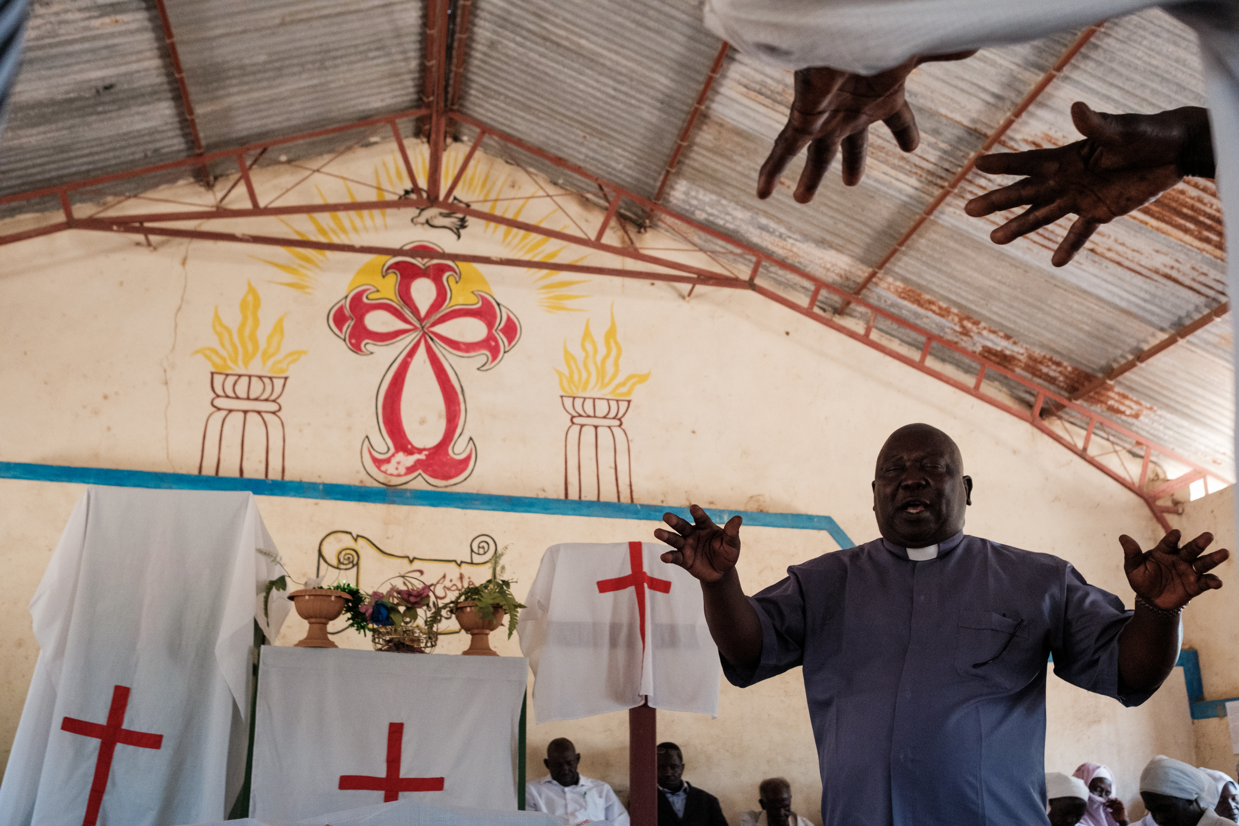 Pastor Yagub Ibrahim Tia blesses donated food during an easter Sunday church service In Kauda on April 20, 2025. The Nuba mountains is Sudans christian stronghold with 75% of the population part of the faith. Secularism is one of the core values that the ruling rebel group, the SPLM-N, has been fighting the Sudanese government for decades.
