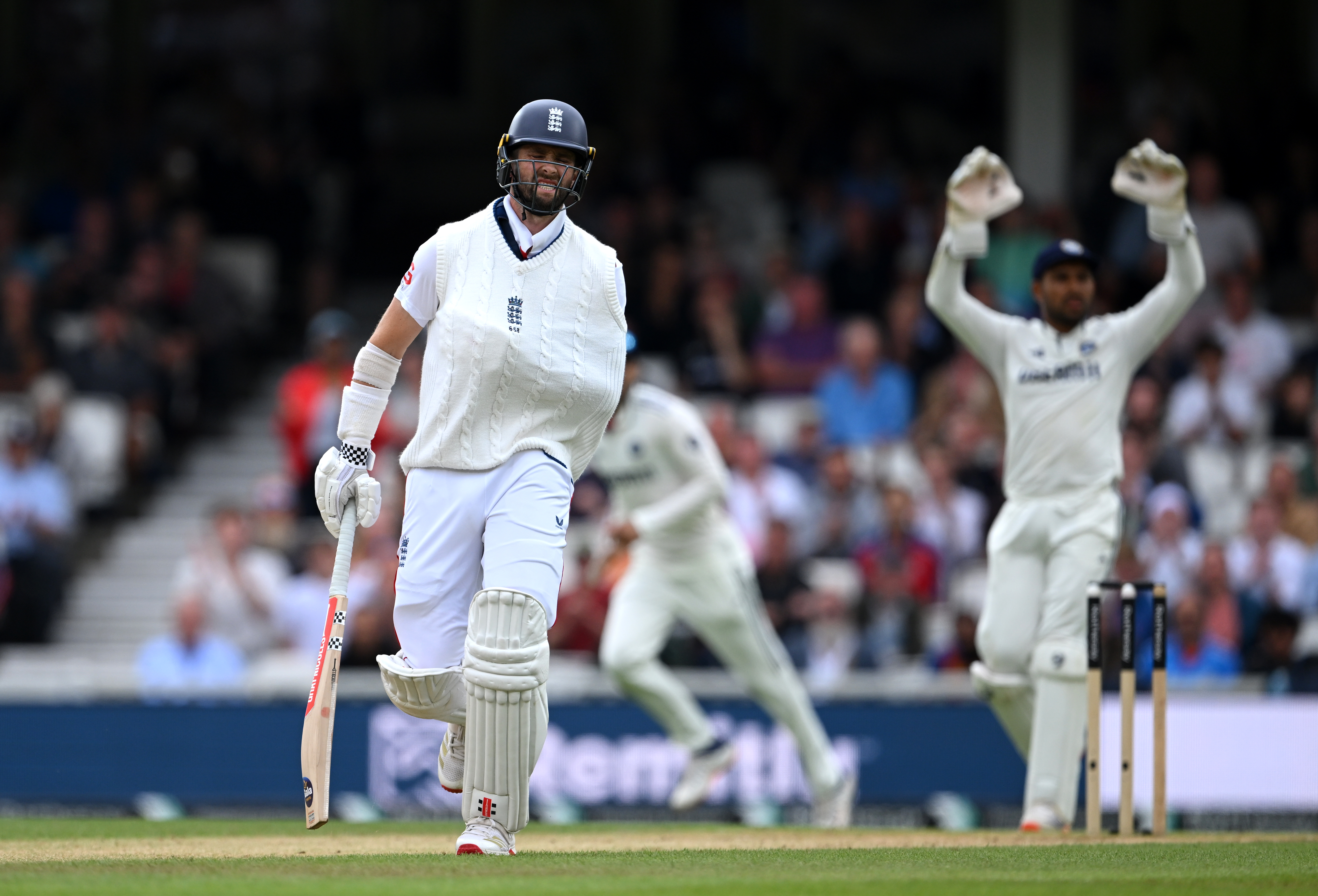 Chris Woakes of England grimaces after making a run as he bats with his arm in a sling on day five of the 5th Rothesay Test