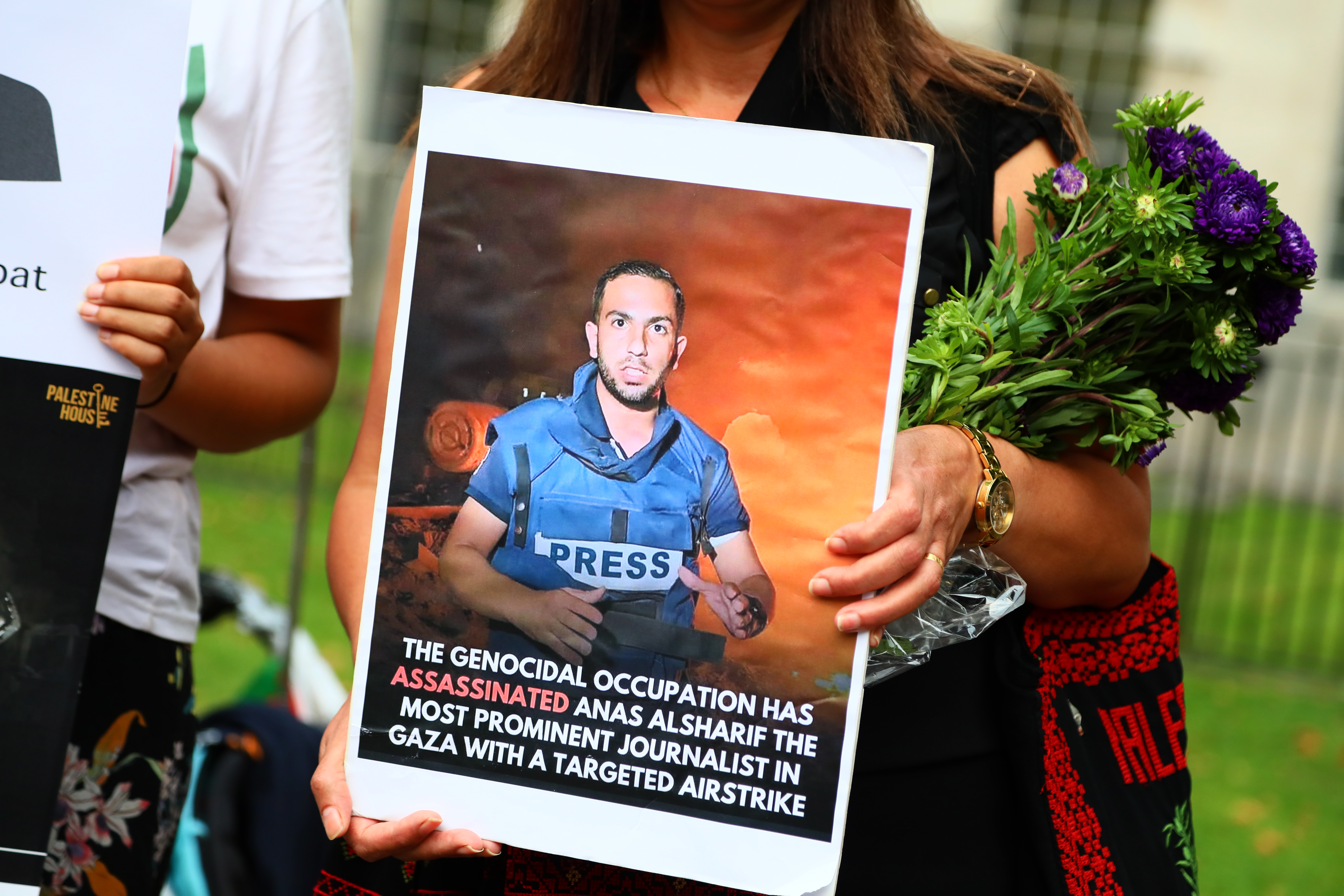 GLAND - AUGUST 13: A woman holds a picture of journalist Anas al-Sharif as NUJ members hold a vigil outside Downing Street