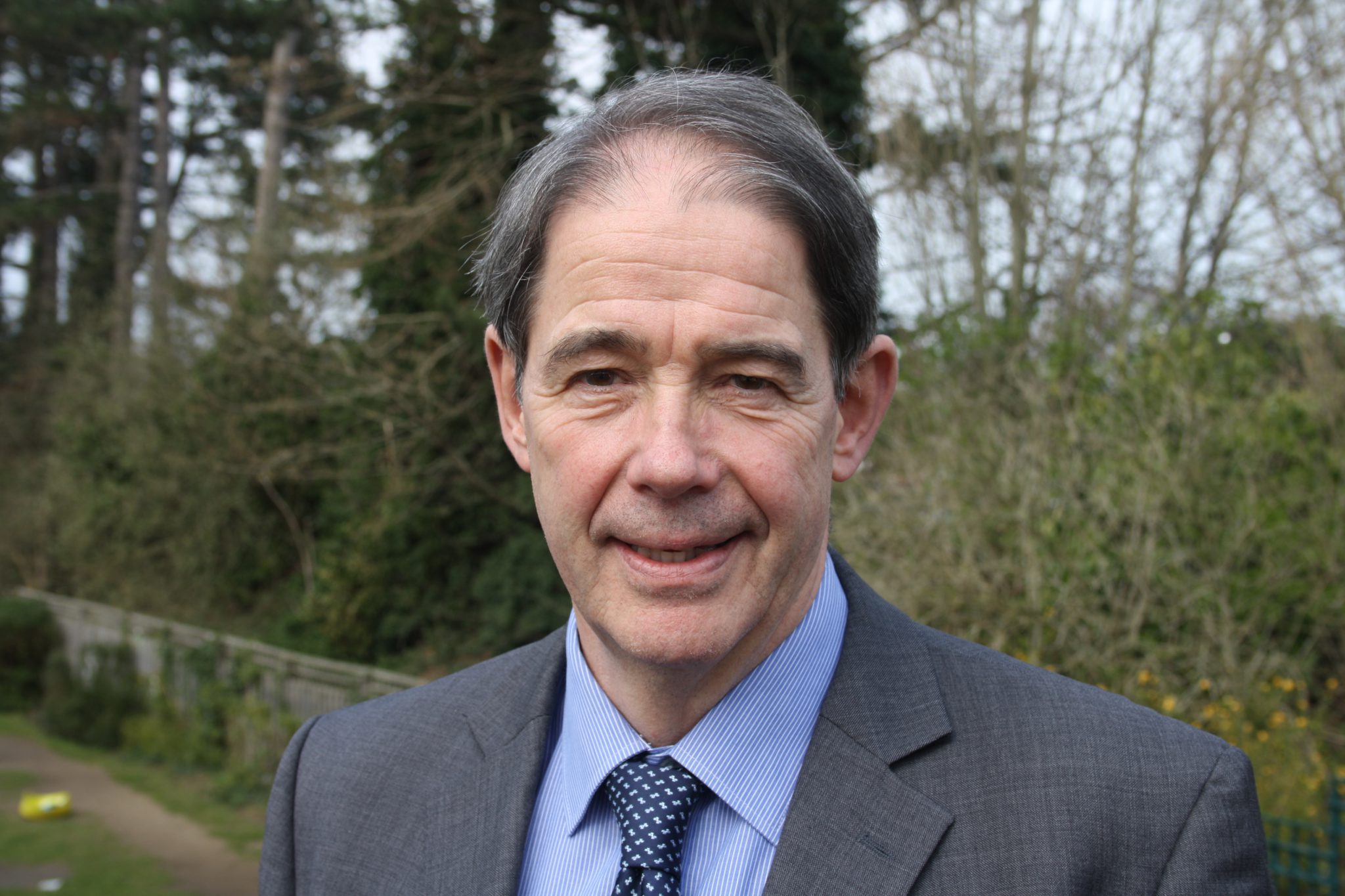 Jonathon Porritt smiling in a suit.