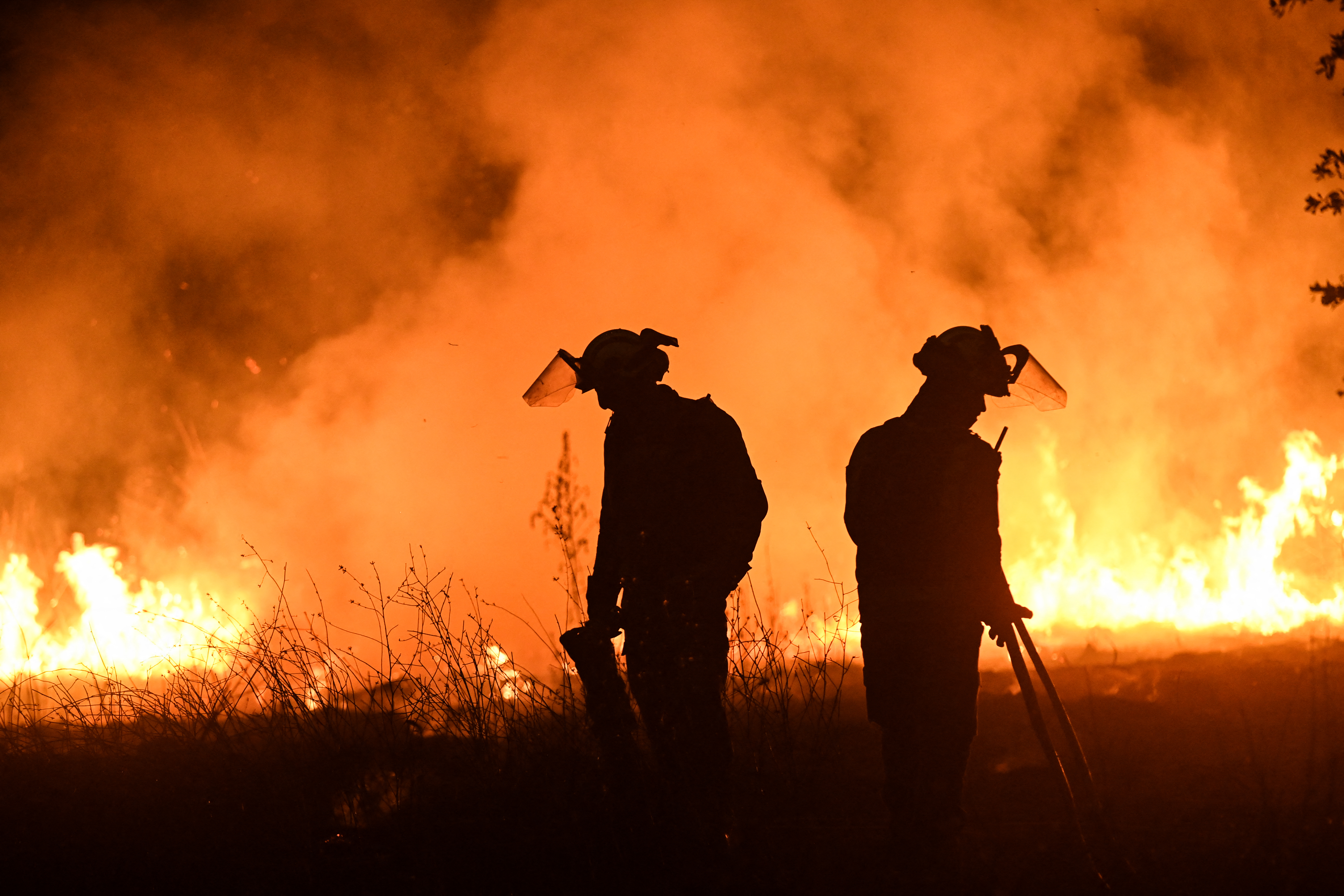 Firefighters work to extinguish a wildfire.