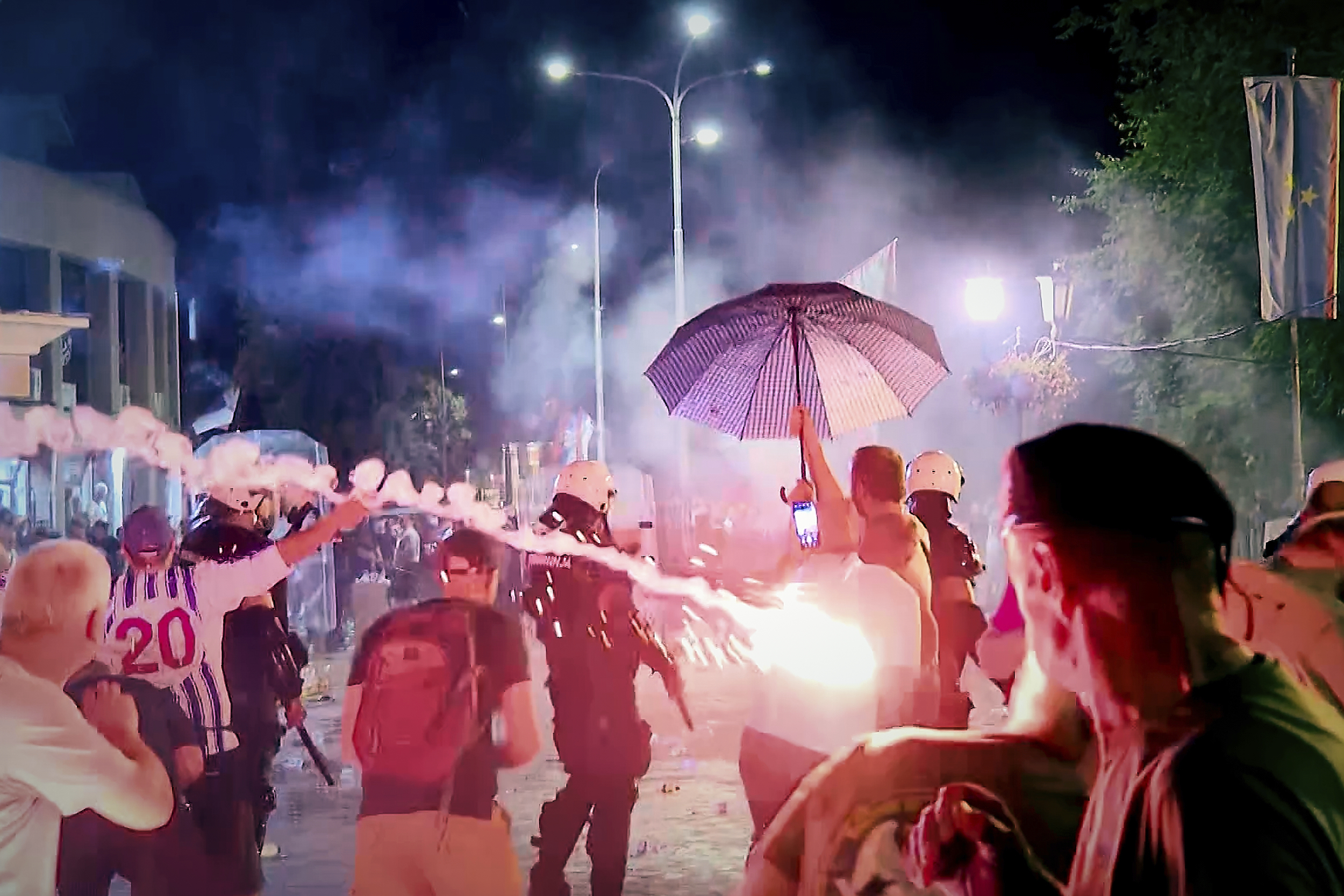 An image taken from video shows fireworks flying as clashes erupted at protests in Vrbas, Serbia, Tuesday, Aug. 12, between opponents and supporters of the government in an escalation of tensions following more than nine months of persistent demonstrations against populist President Aleksandar Vucic. (N1 Serbia via AP)