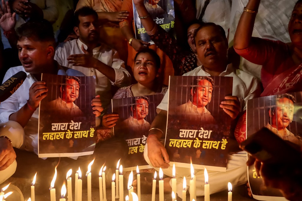 Supporters take part in a candlelight vigil protesting against the arrest of climate activist Sonam Wangchuk, at Jantar Mantar in New Delhi on September 26, 2025. [AFP]