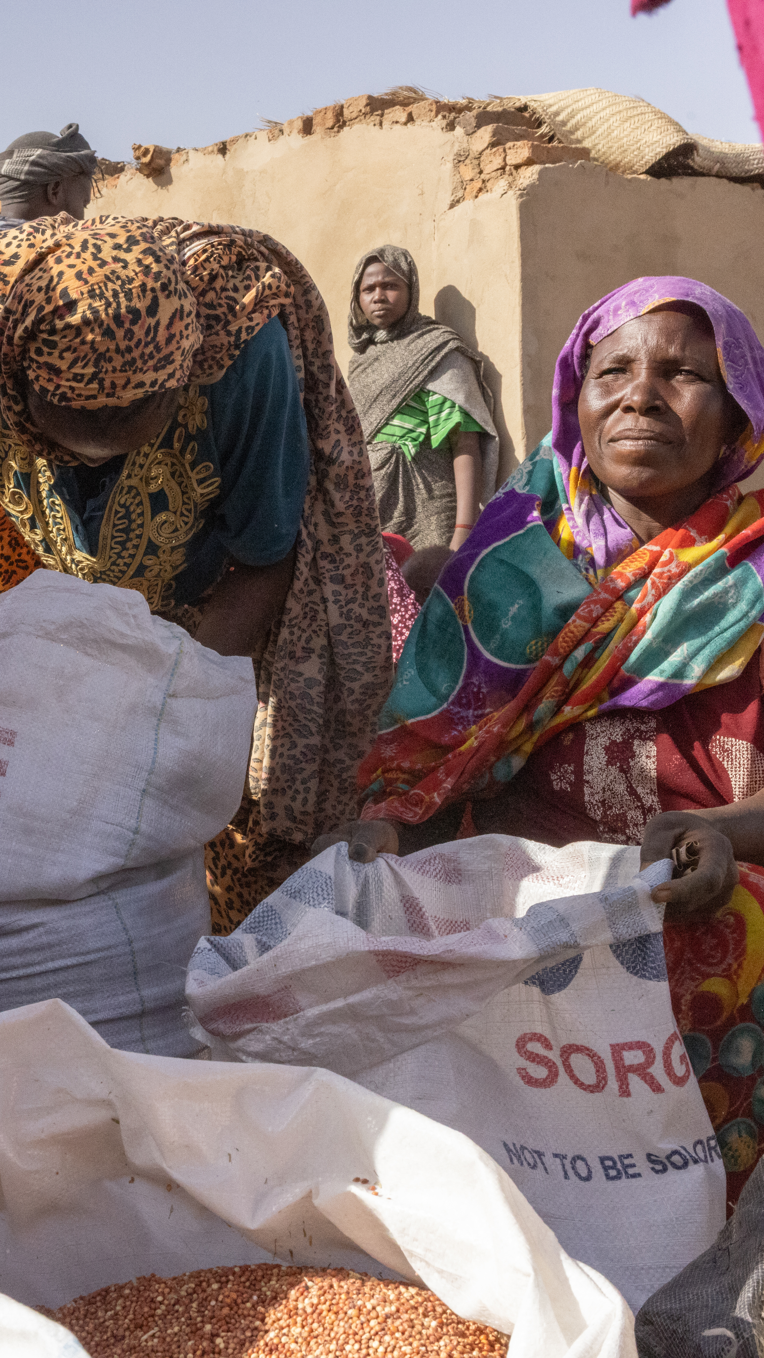 Refugees divide up rations from the World Food Program in Adre, Eastern Chad 08 May 2025