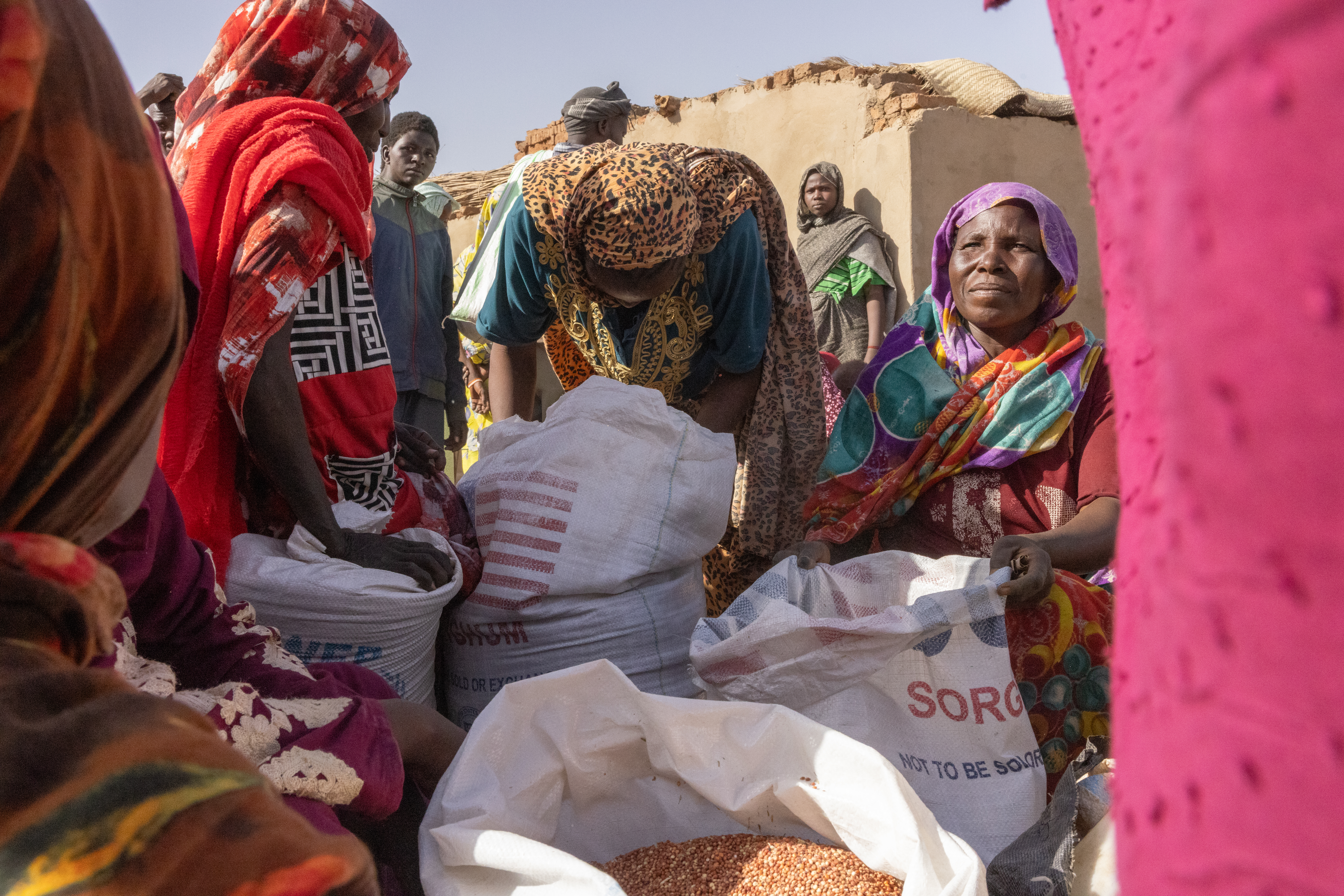 Refugees divide up rations from the World Food Program in Adre, Eastern Chad 08 May 2025