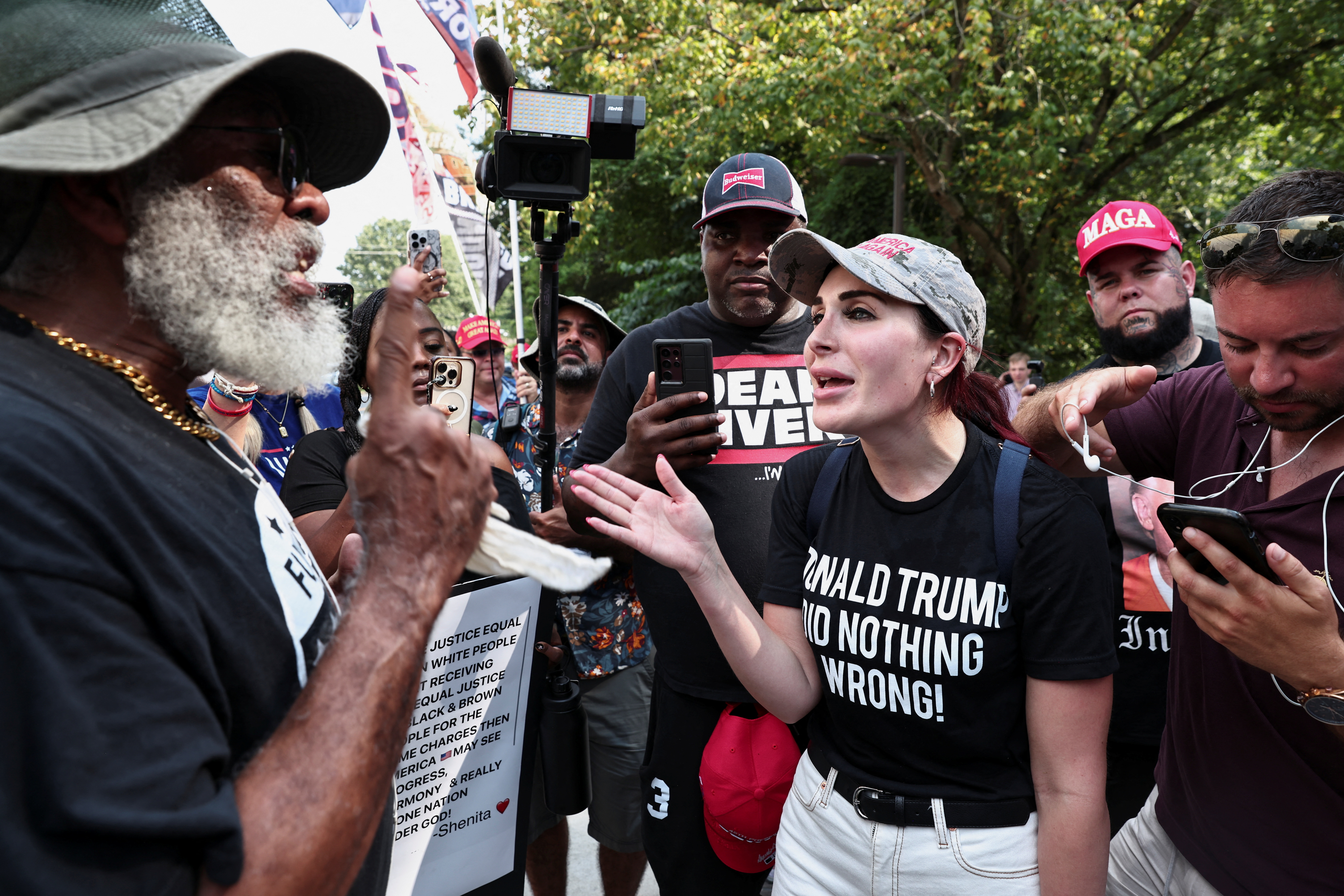 Laura Loomer, far-right activist, speaks with anti-Trump demonstrators near the entrance of the Fulton County Jail, as former U.S. President Donald Trump is expected to turn himself in to be processed after his Georgia indictment, in Atlanta, Georgia, U.S., August 24, 2023. REUTERS/Dustin Chambers