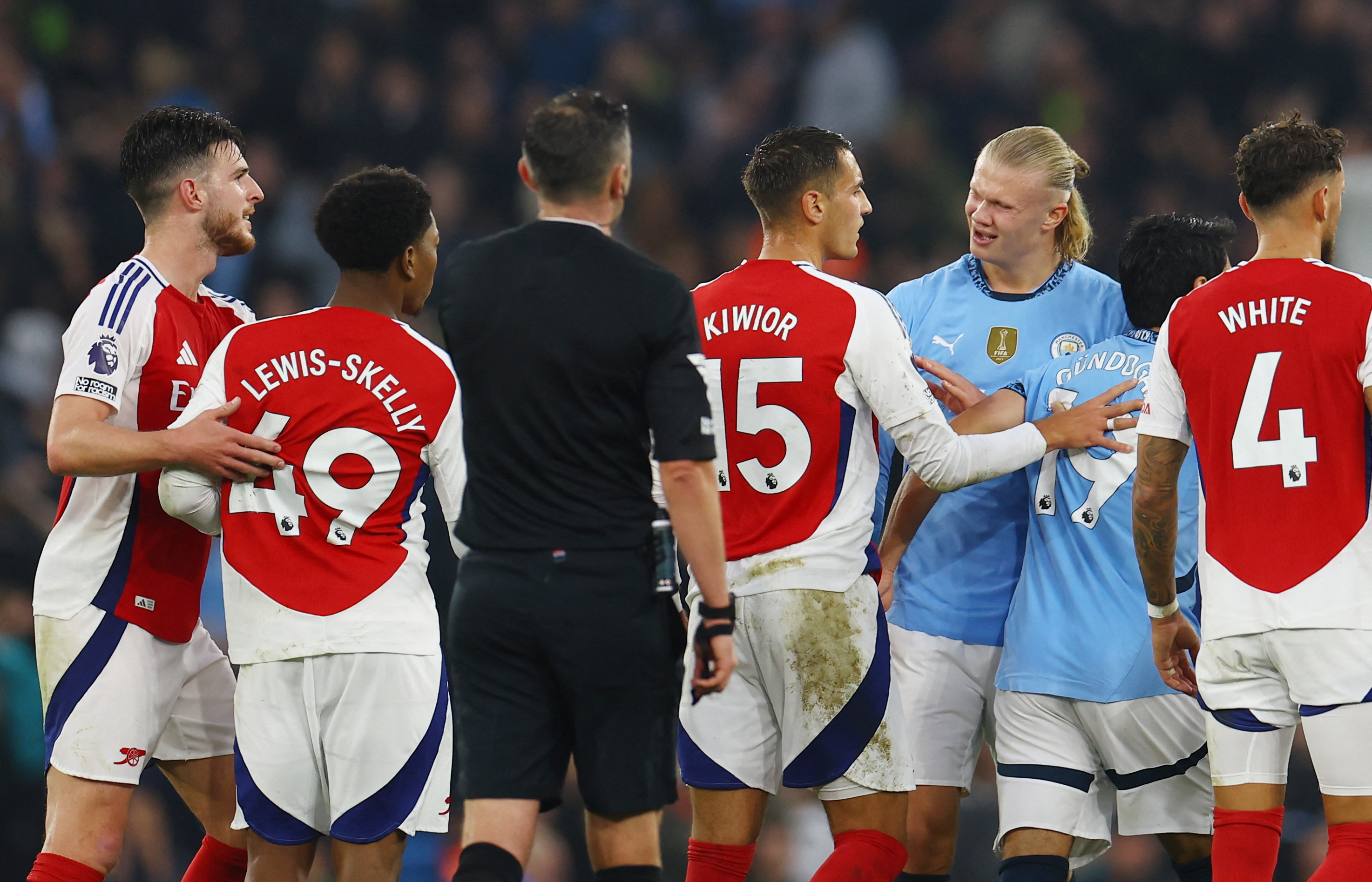 Arsenal's Myles Lewis-Skelly clashes with Manchester City's Erling Haaland 