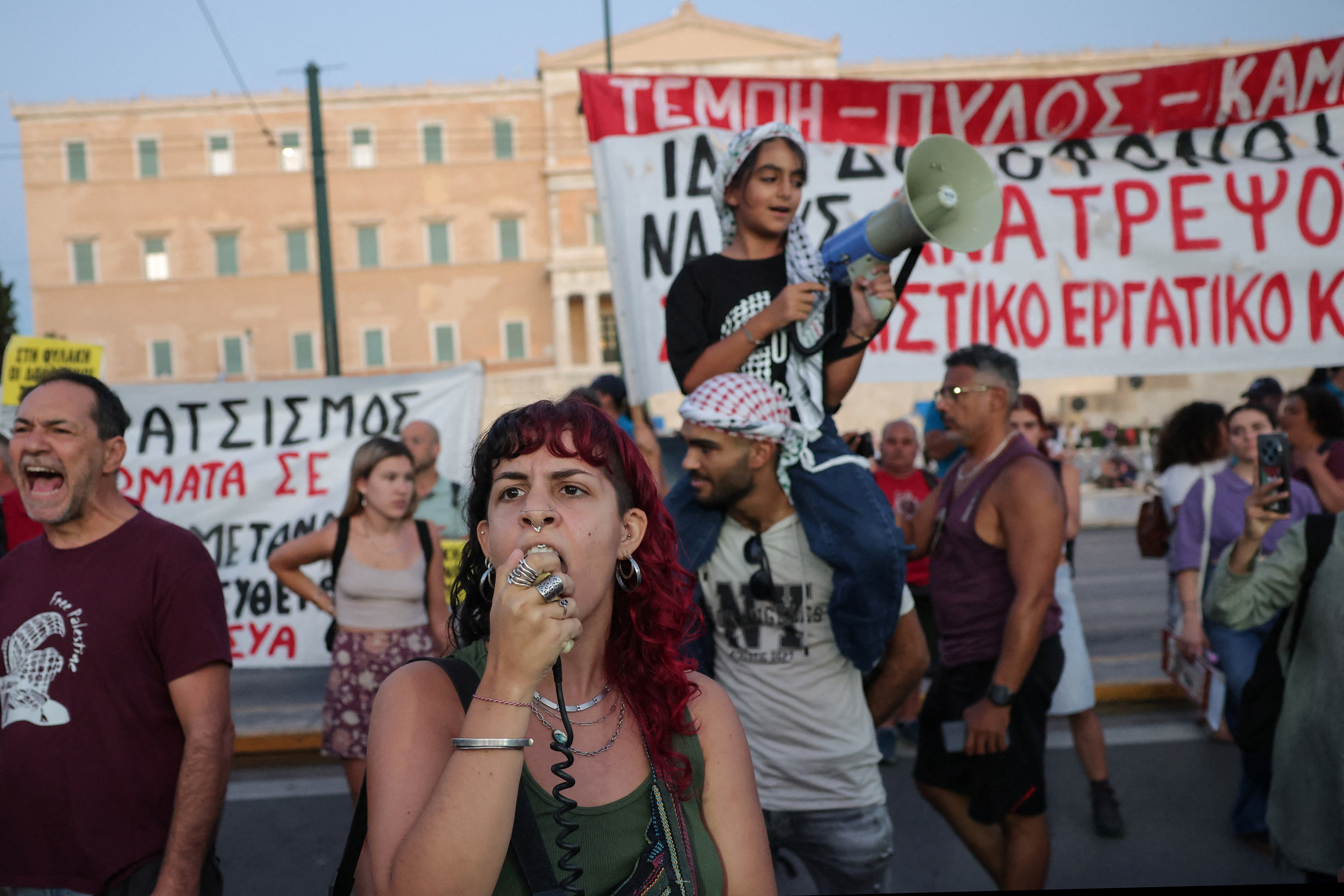 A protester shouts as Greek anti-racism groups and migrants hold a rally in Athens, Greece