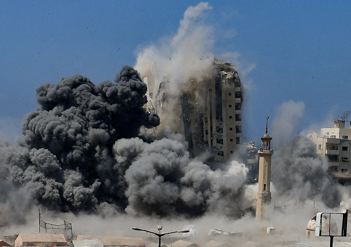 Smoke rises as a building is hit by an Israeli strike, in Gaza City
