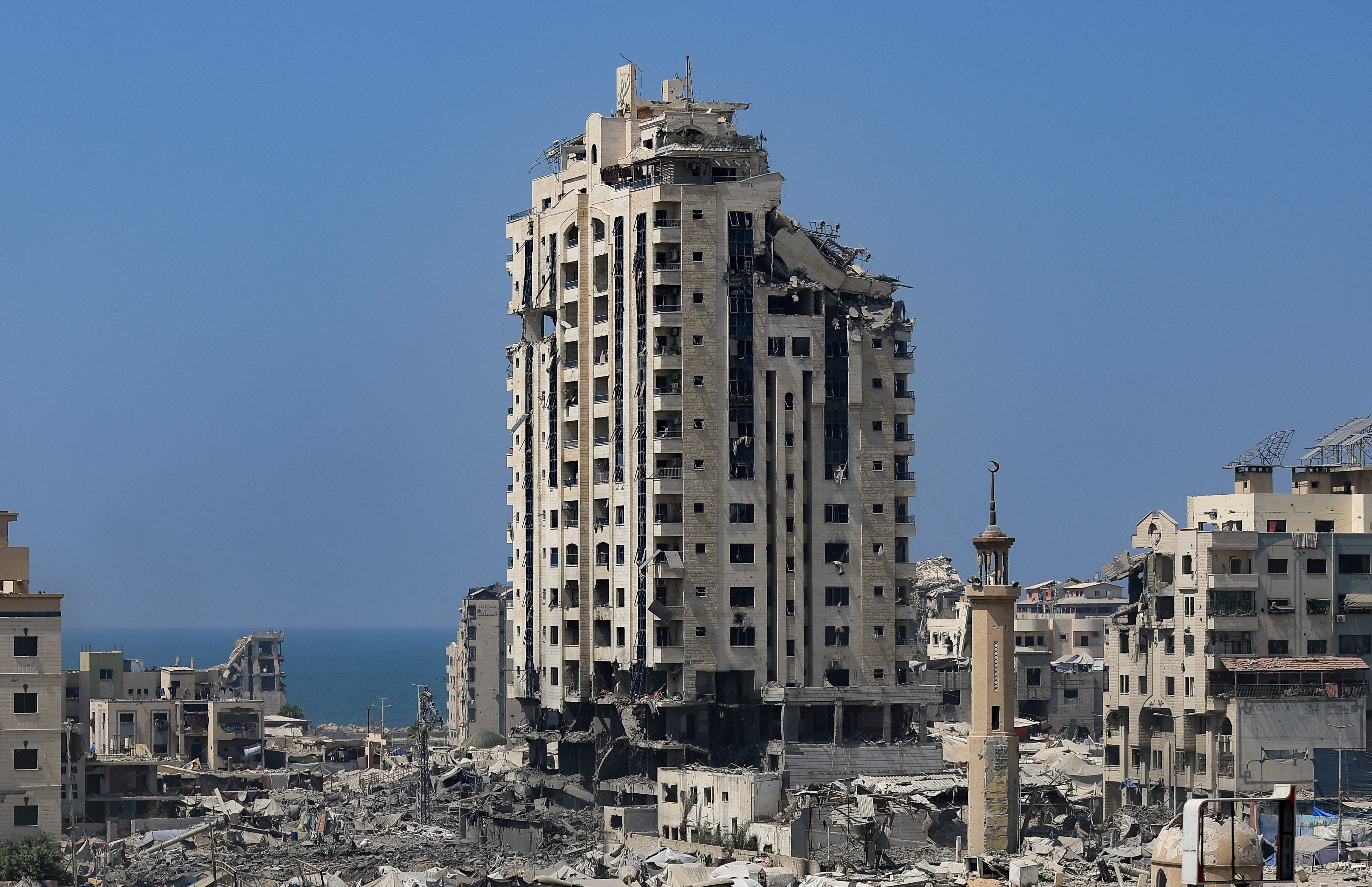 A damaged building stands ahead of an Israeli strike, in Gaza City