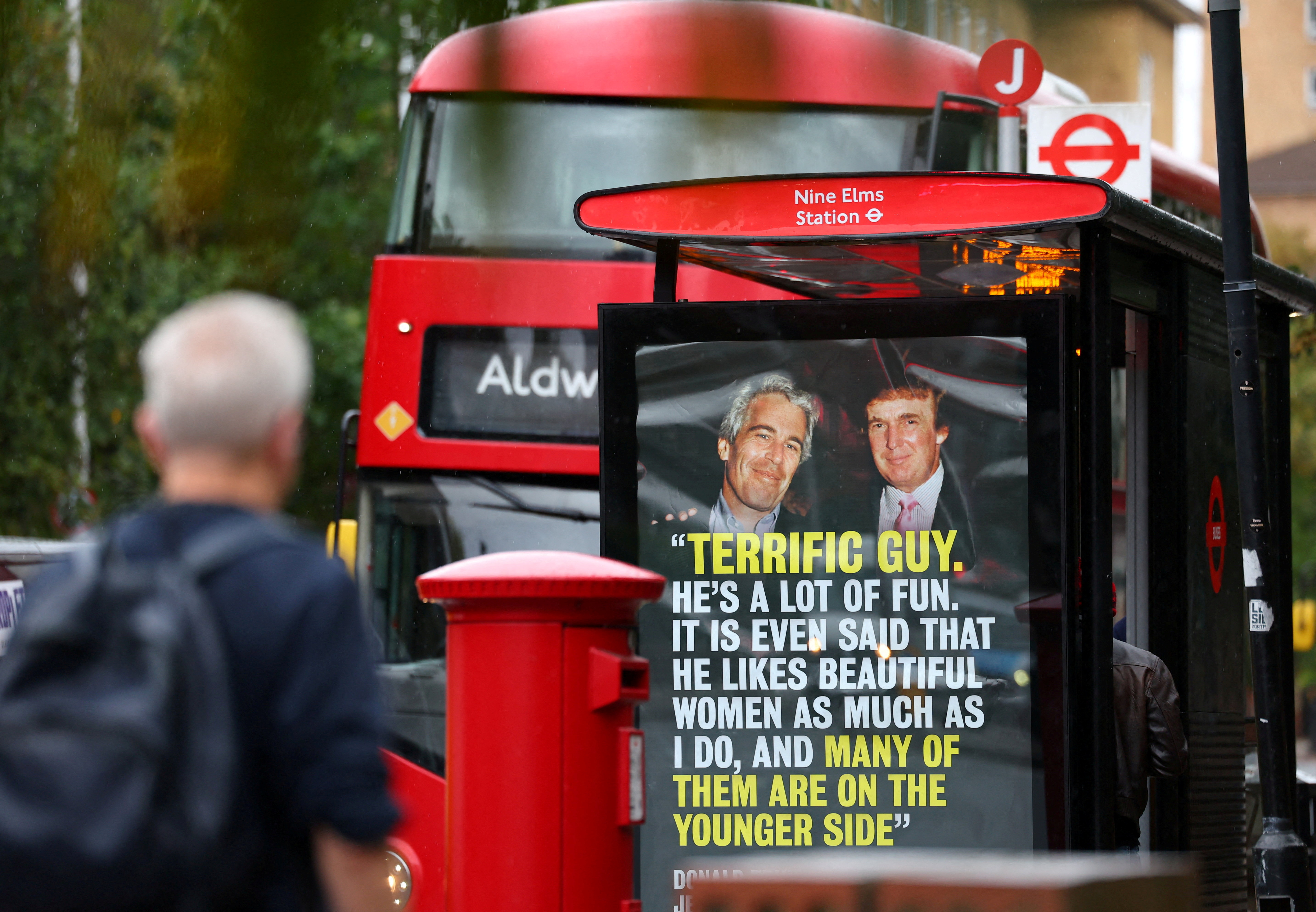 FILE PHOTO: A person walks past a poster with a photograph of Donald Trump, now serving as the U.S. President, and disgraced financier and sex offender Jeffrey Epstein, protesting Trump's upcoming state visit to the UK, in London, Britain, September 3, 2025. REUTERS/Isabel Infantes/File Photo