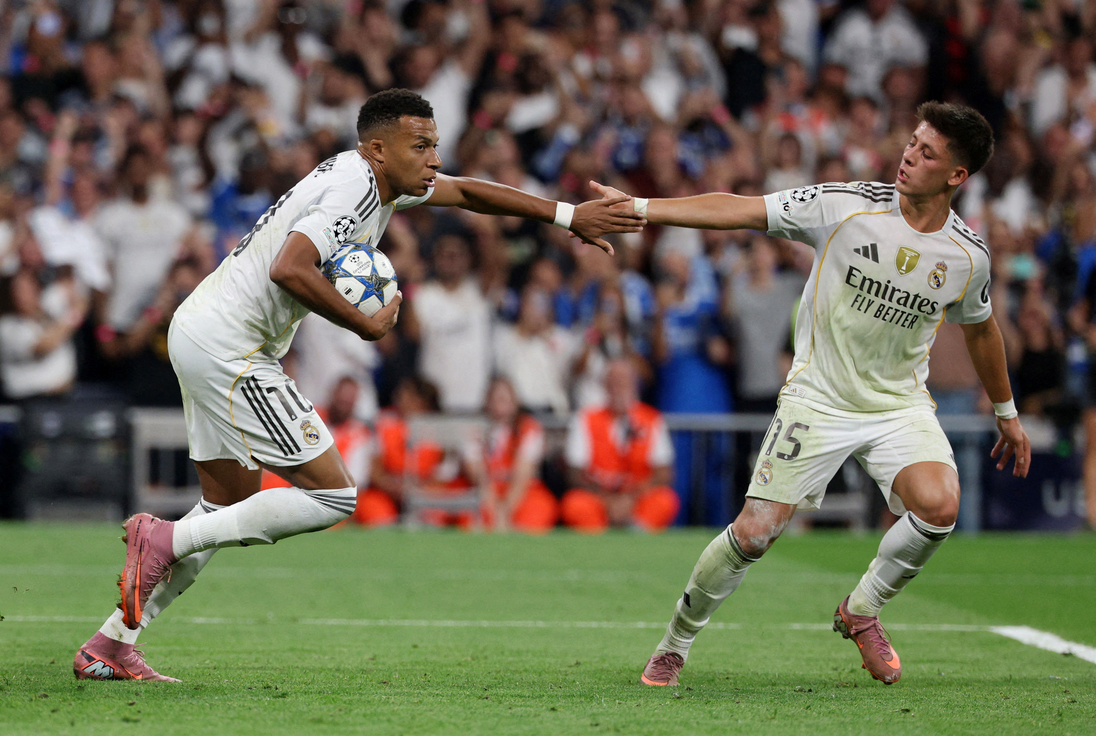Real Madrid's Kylian Mbappe celebrates scoring their first goal with Arda Guler