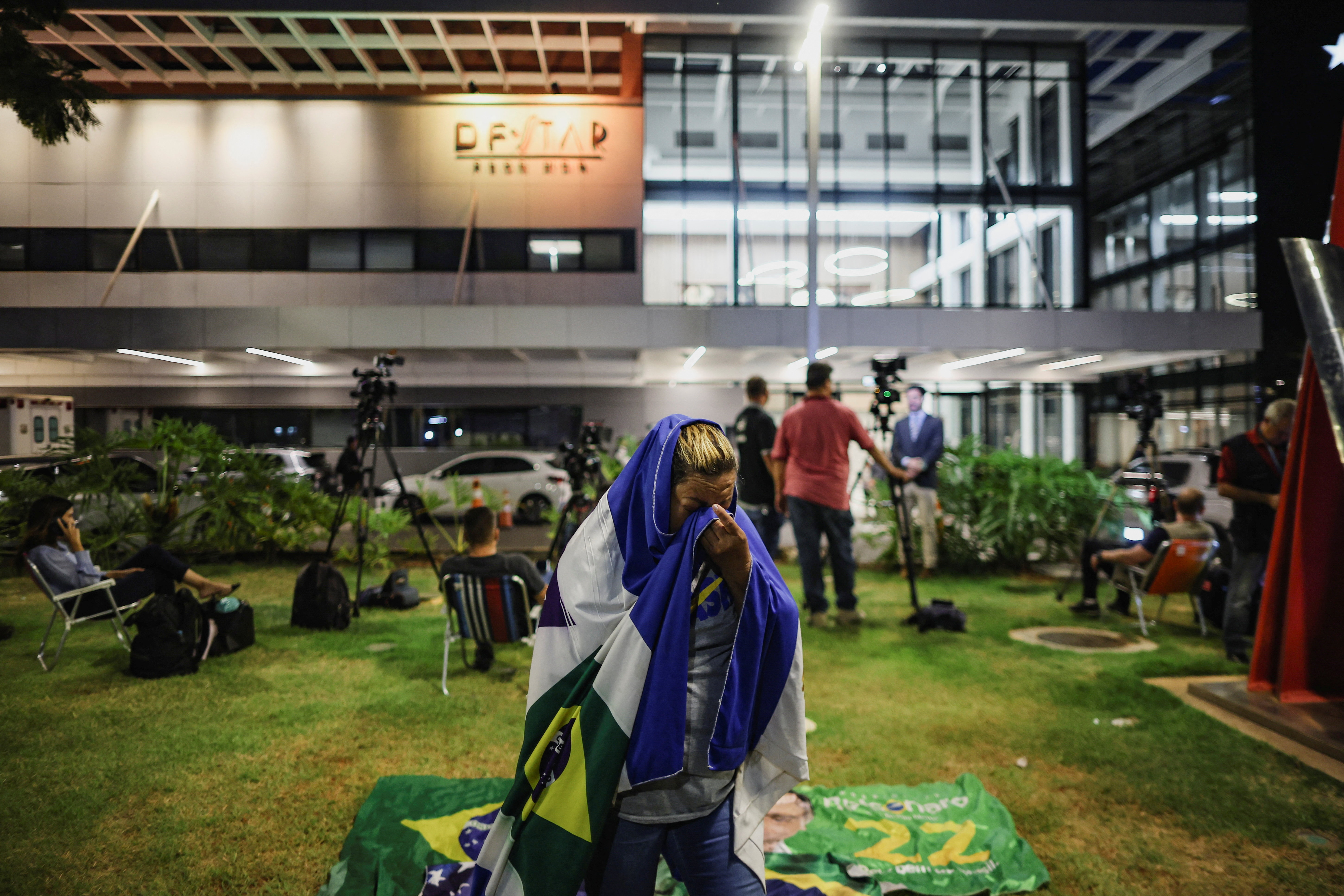 A supporter reacts outside the hospital on September 16 where former Brazilian President Jair Bolsonaro was taken after feeling sick, according to his son Flavio. [Adriano Machado/Reuters[