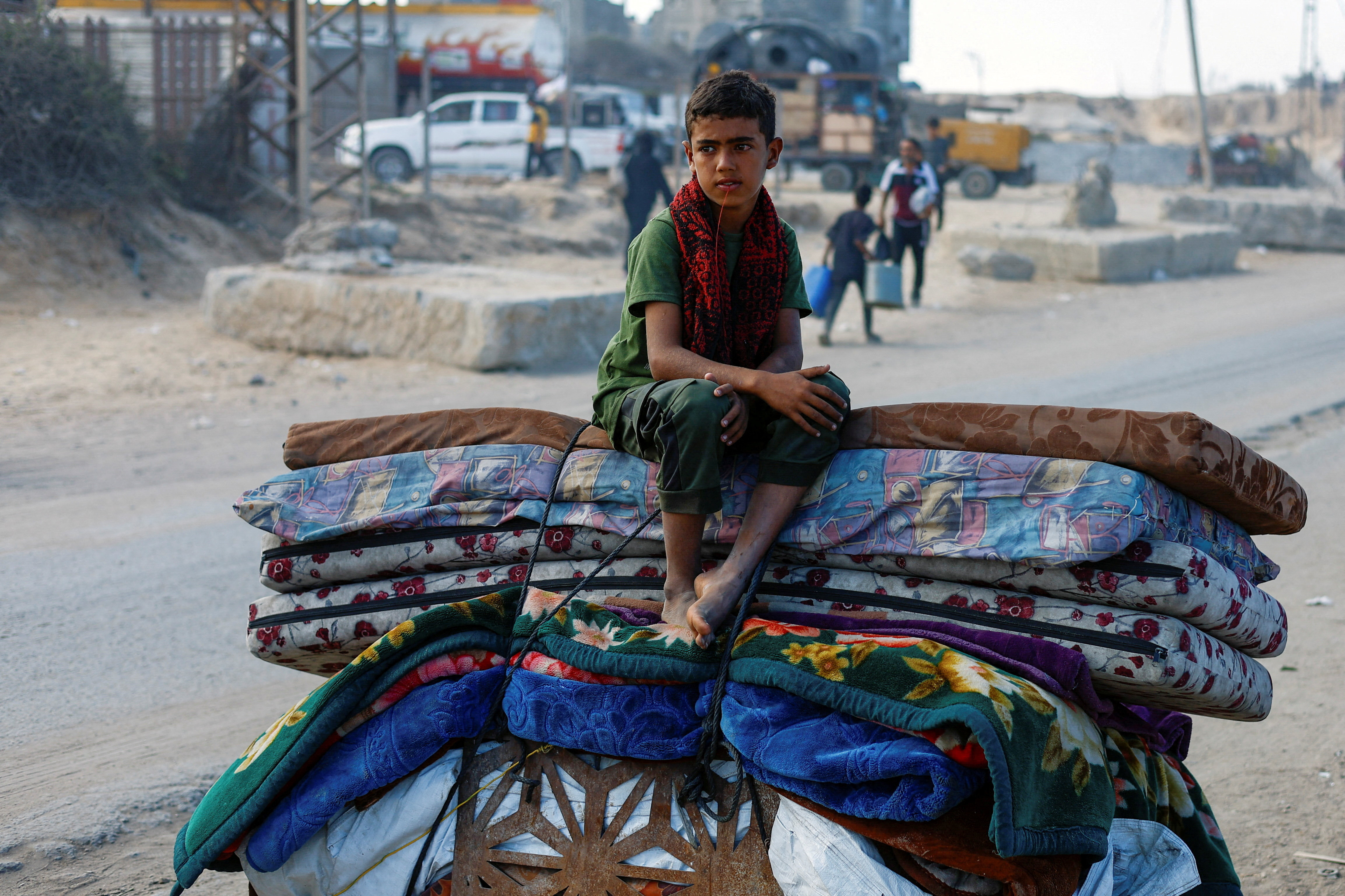 A displaced Palestinian boy displaced by Israeli orders flees northern Gaza, September 17, 2025. [Mahmoud Issa/Reuters]