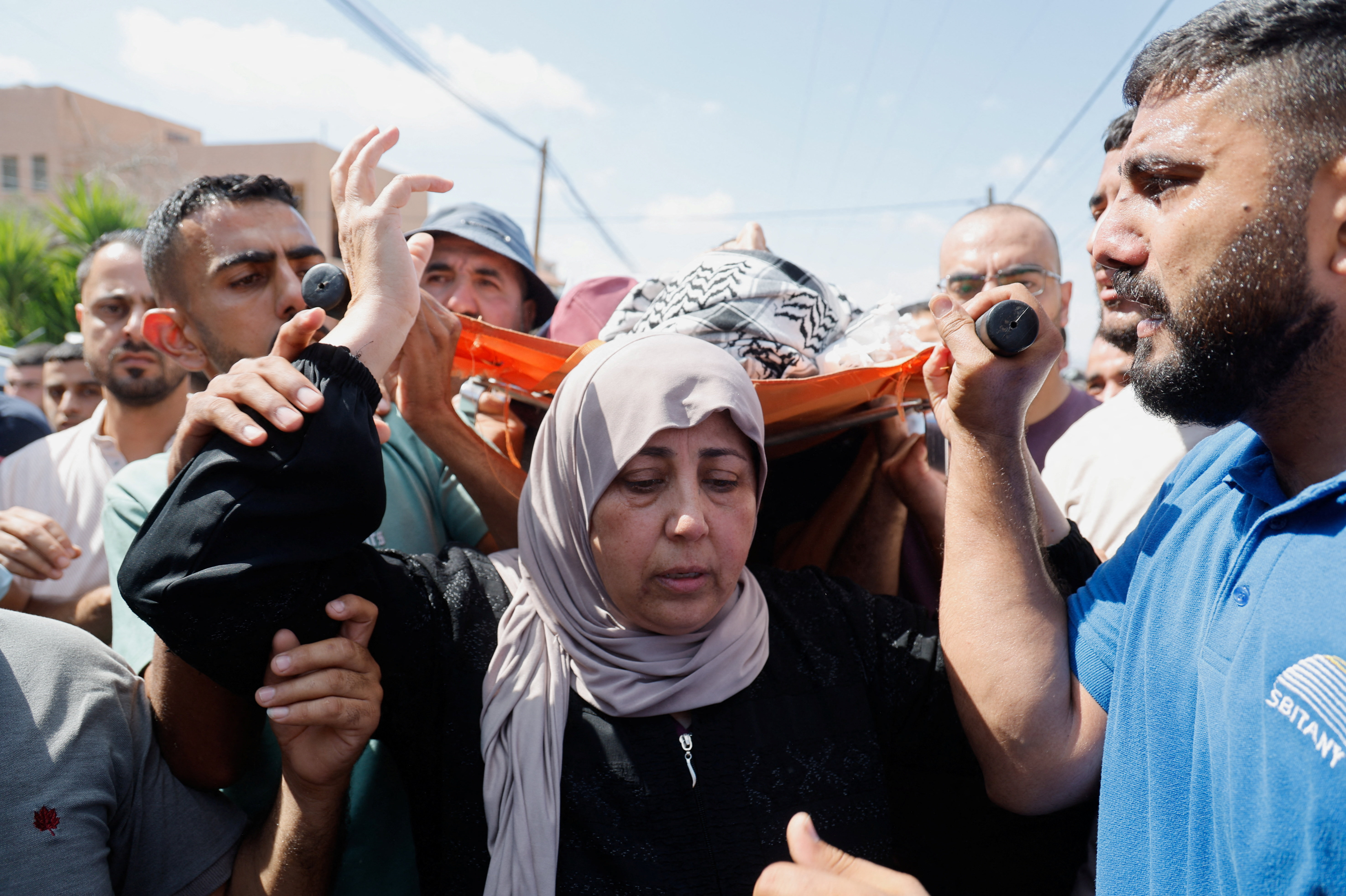 Mourners carry the body of a youth killed by Israeli army in Anza, near Jenin, in the occupied West Bank