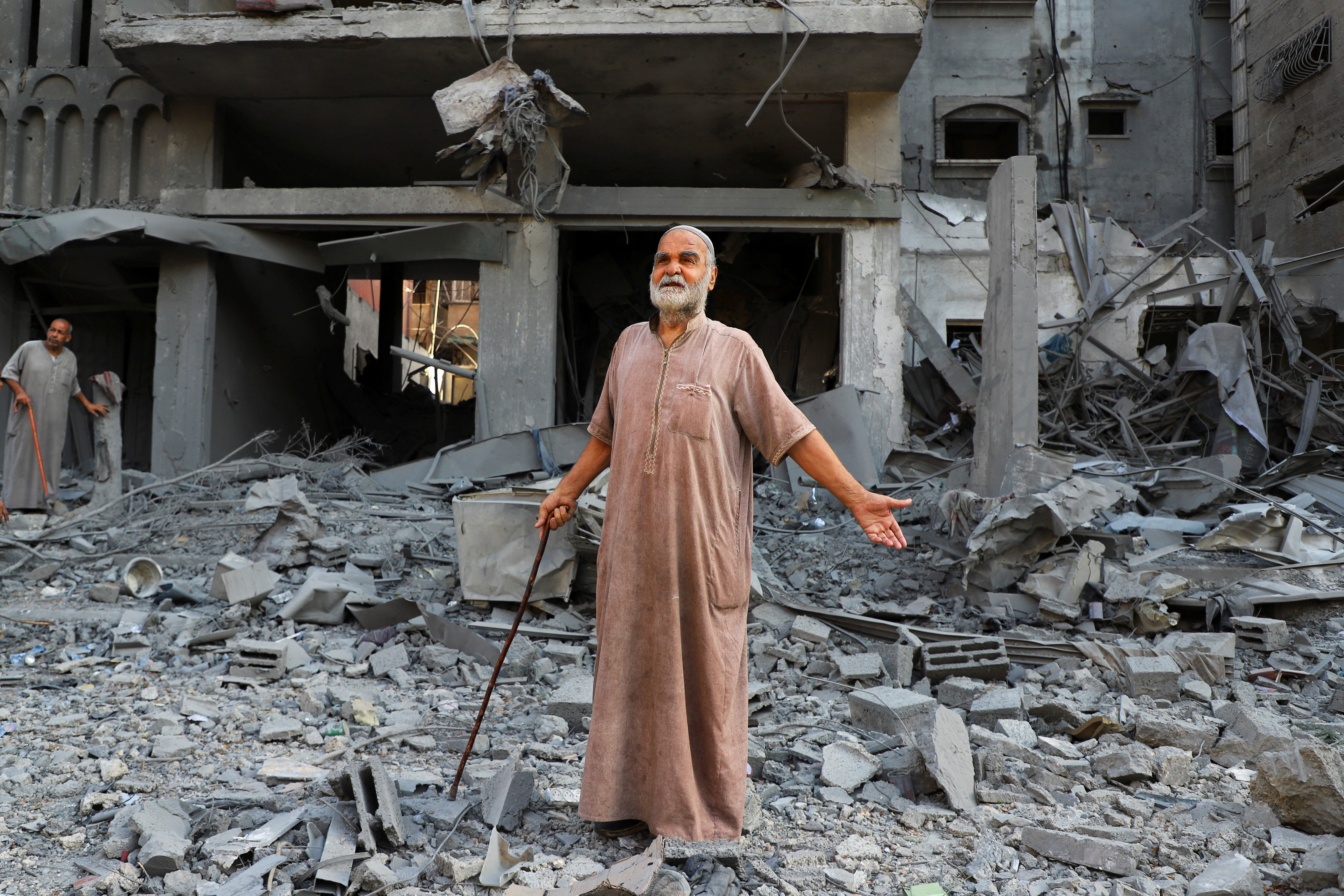 A Palestinian reacts as he inspects the site of Israeli strikes on houses at Shati (Beach) refugee camp