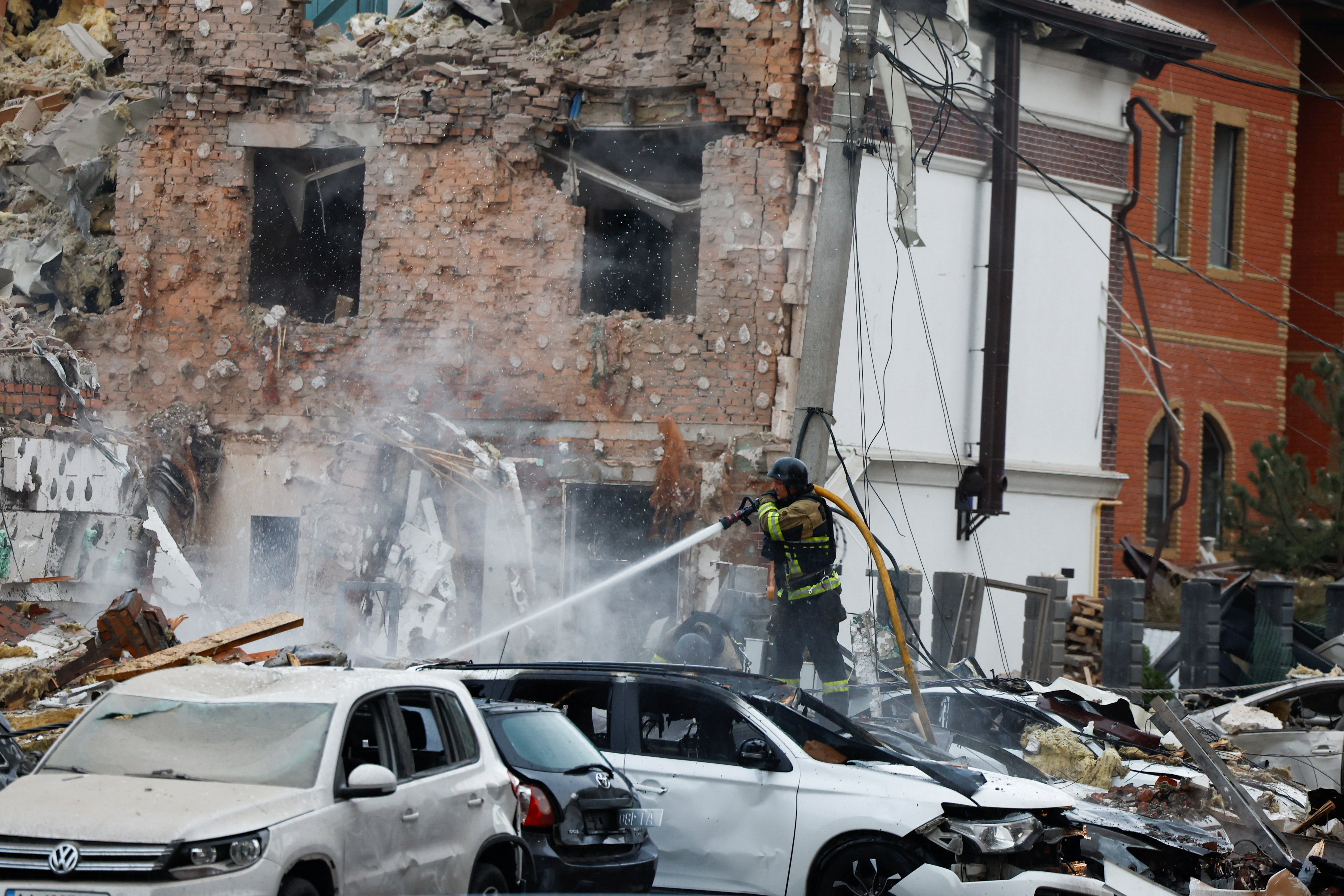 An emergency responder works in a neighbourhood after Russian attacks in Kyiv