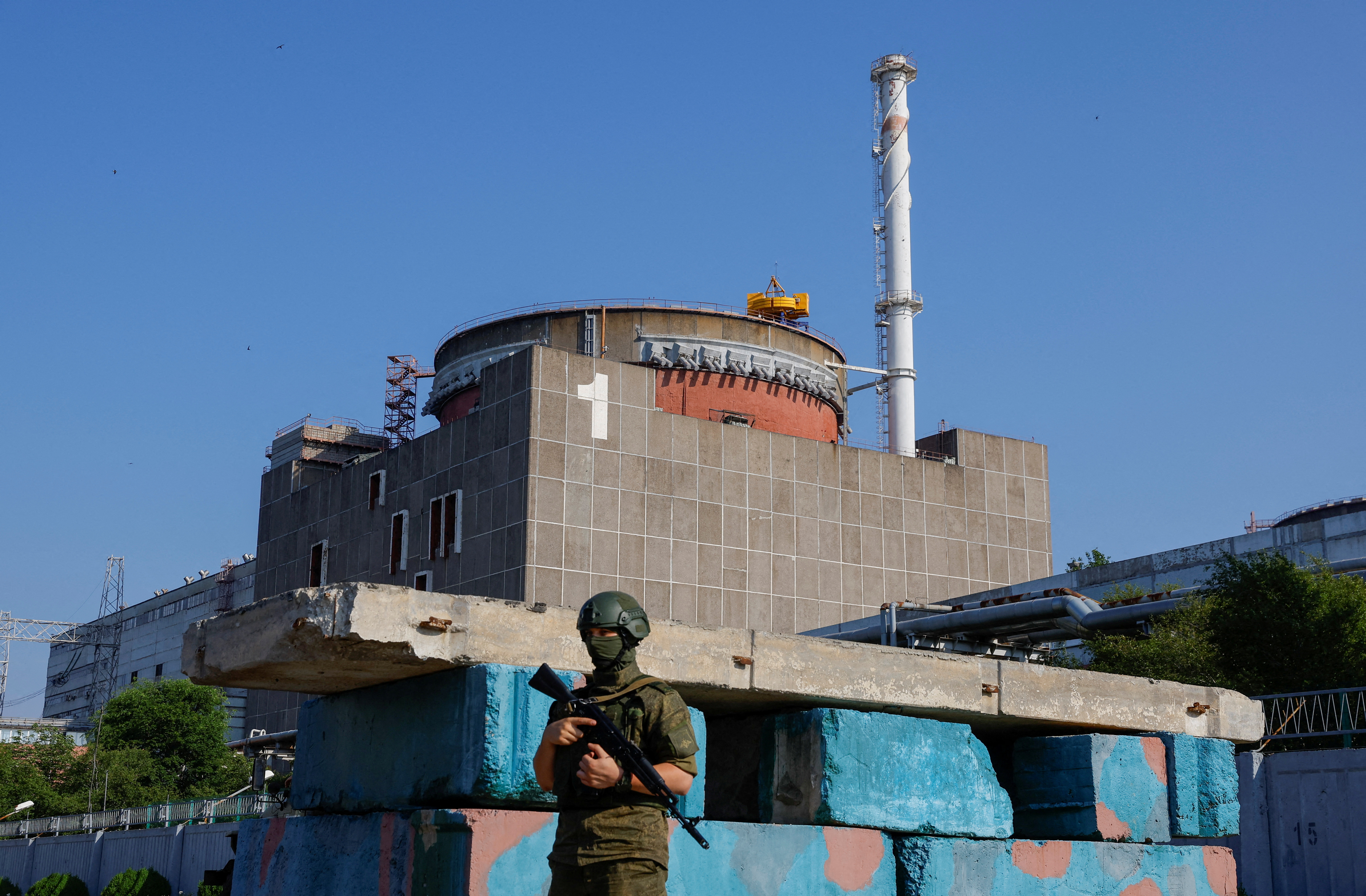 A Russian service member stands guard at a checkpoint near the Zaporizhzhia Nuclear Power Plant [FILE: Alexander Ermochenko/Reuters]