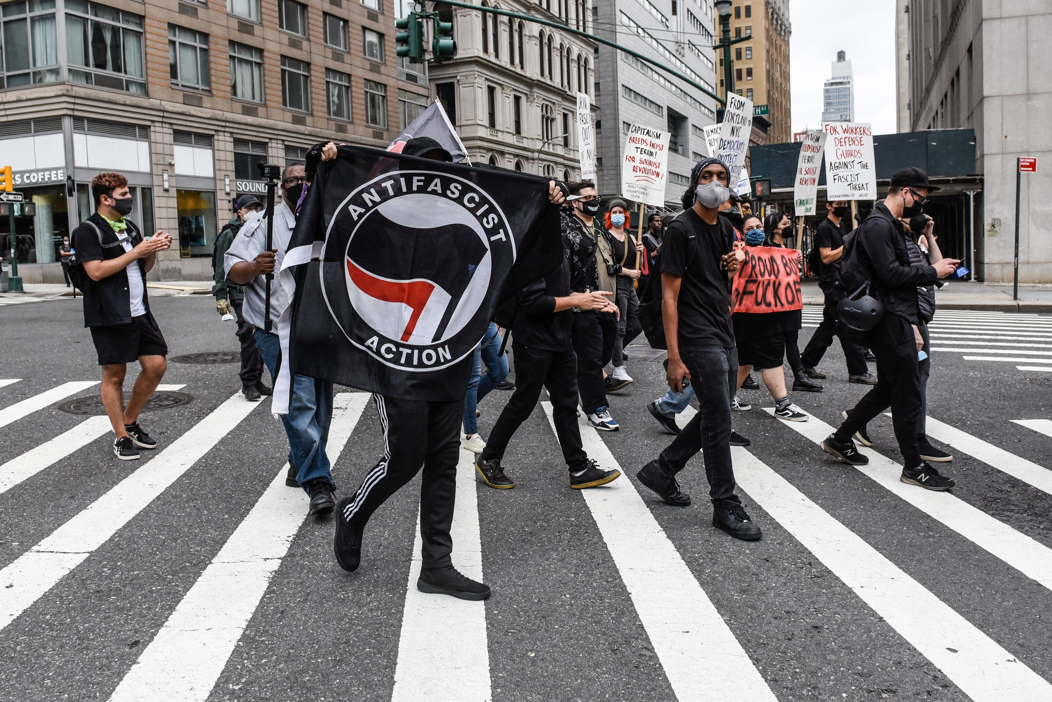 Left wing protesters, some affiliated with Antifa, hold a counter protest against right wing protesters participating in a political rally on July 25, 2021 in New York City. 