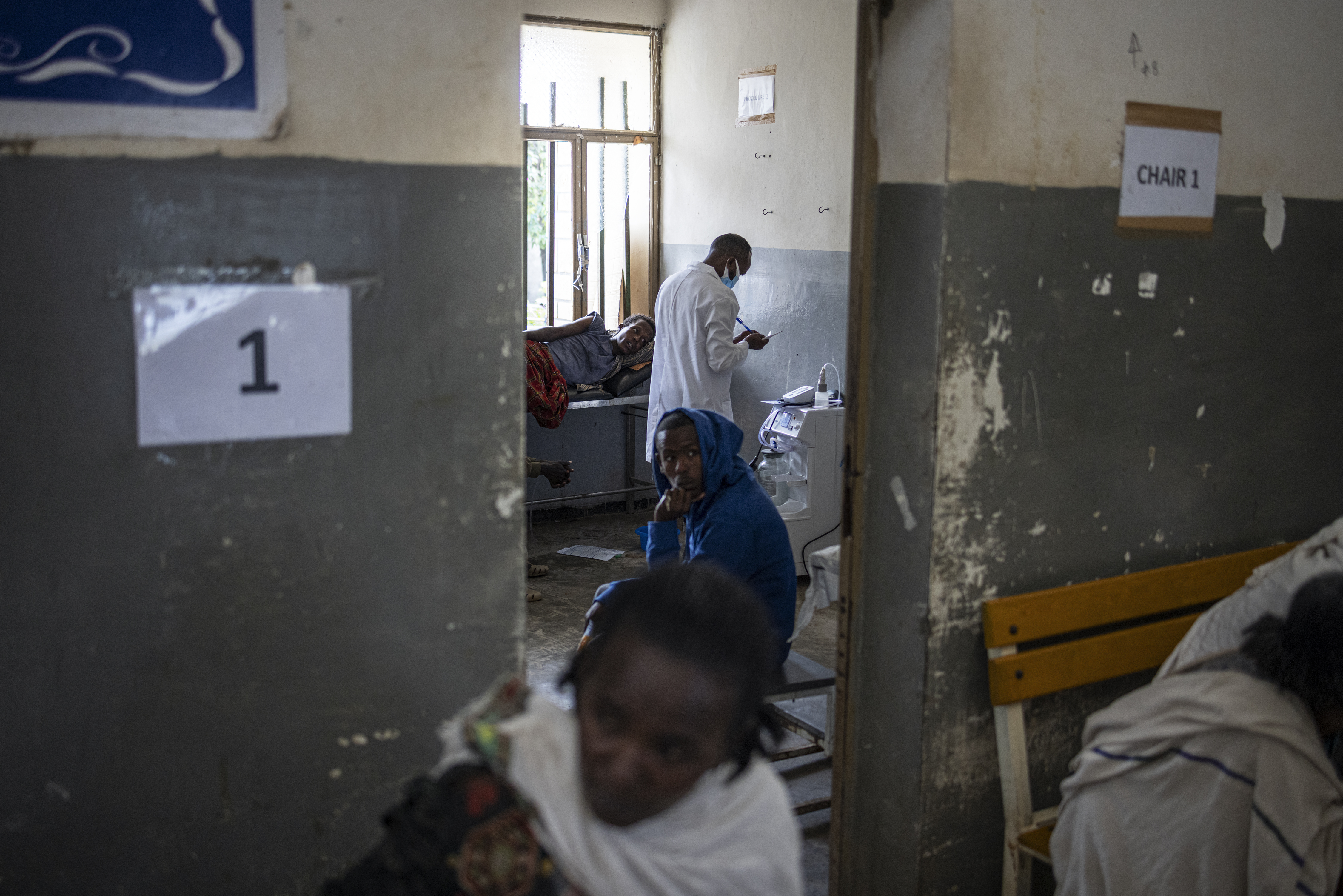 A doctor visits a patient at a ward of a hospital.